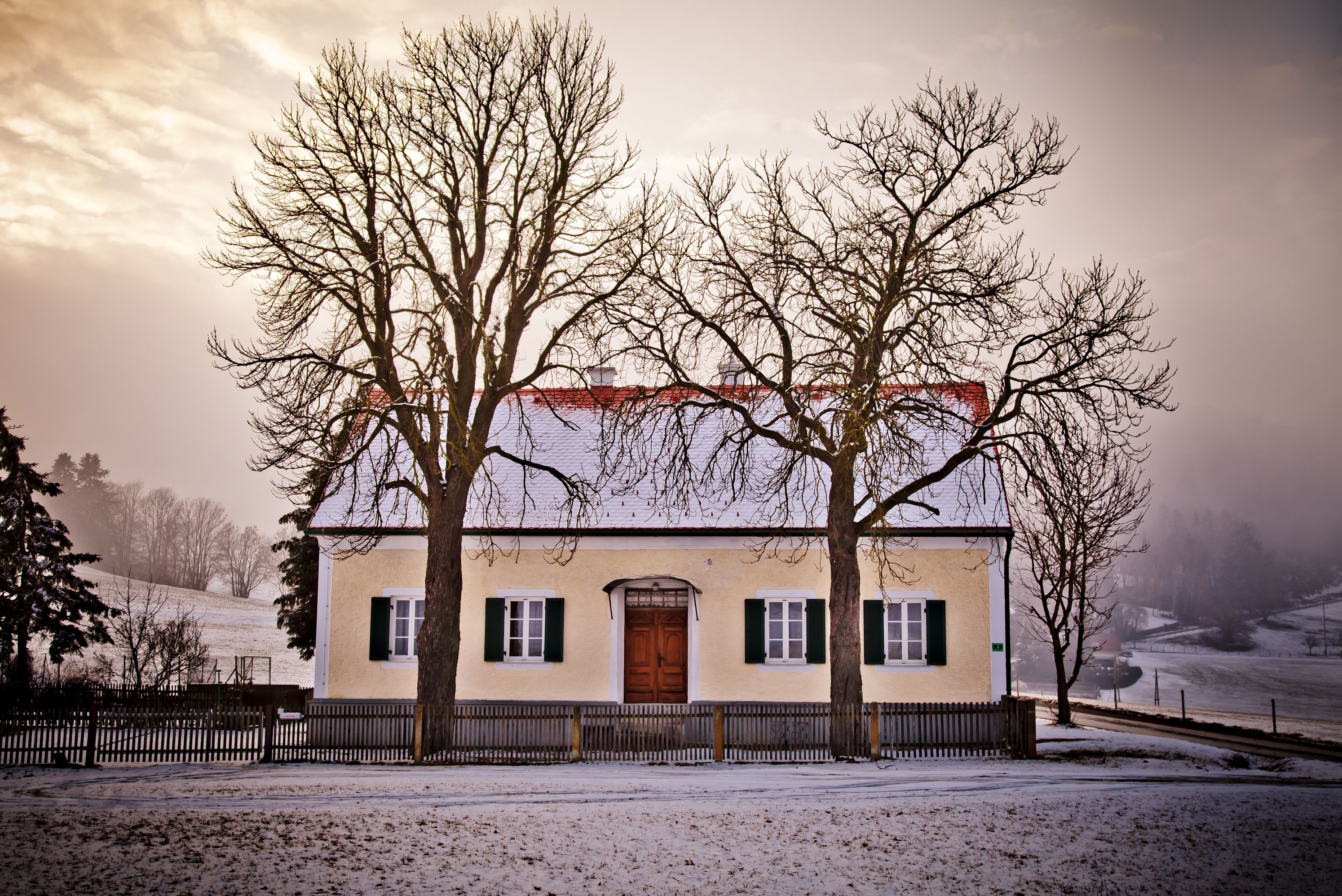 Yellow house with red roof and trees in winter HD Wallpaper