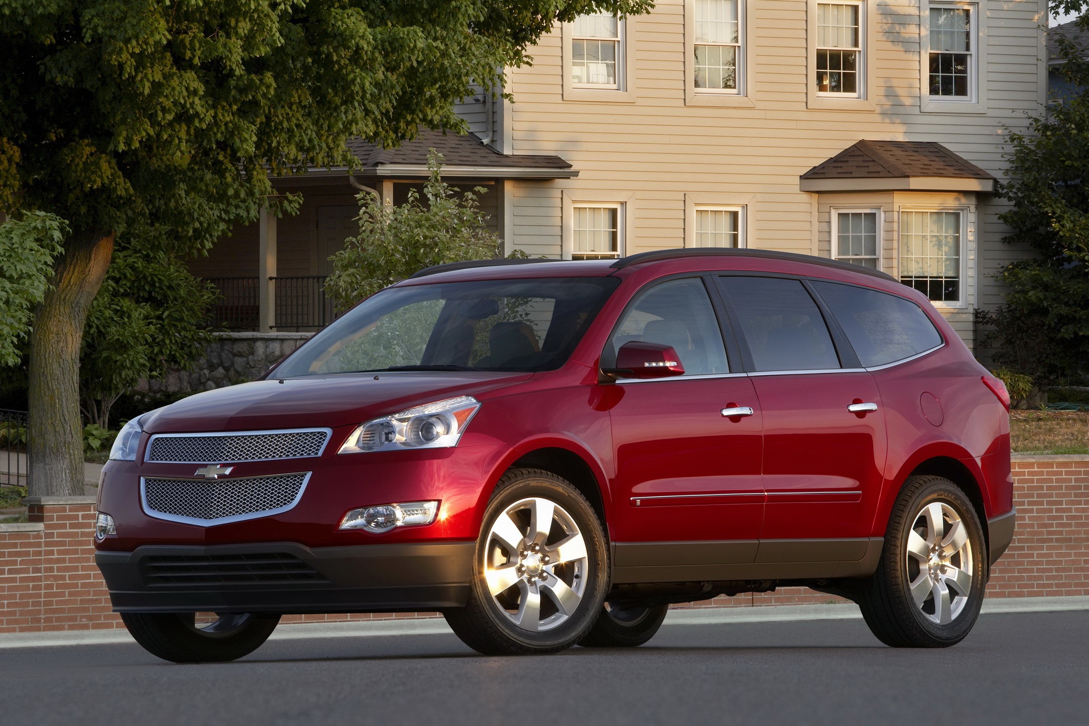 Red Chevrolet Traverse SUV parked outside a house HD Wallpaper