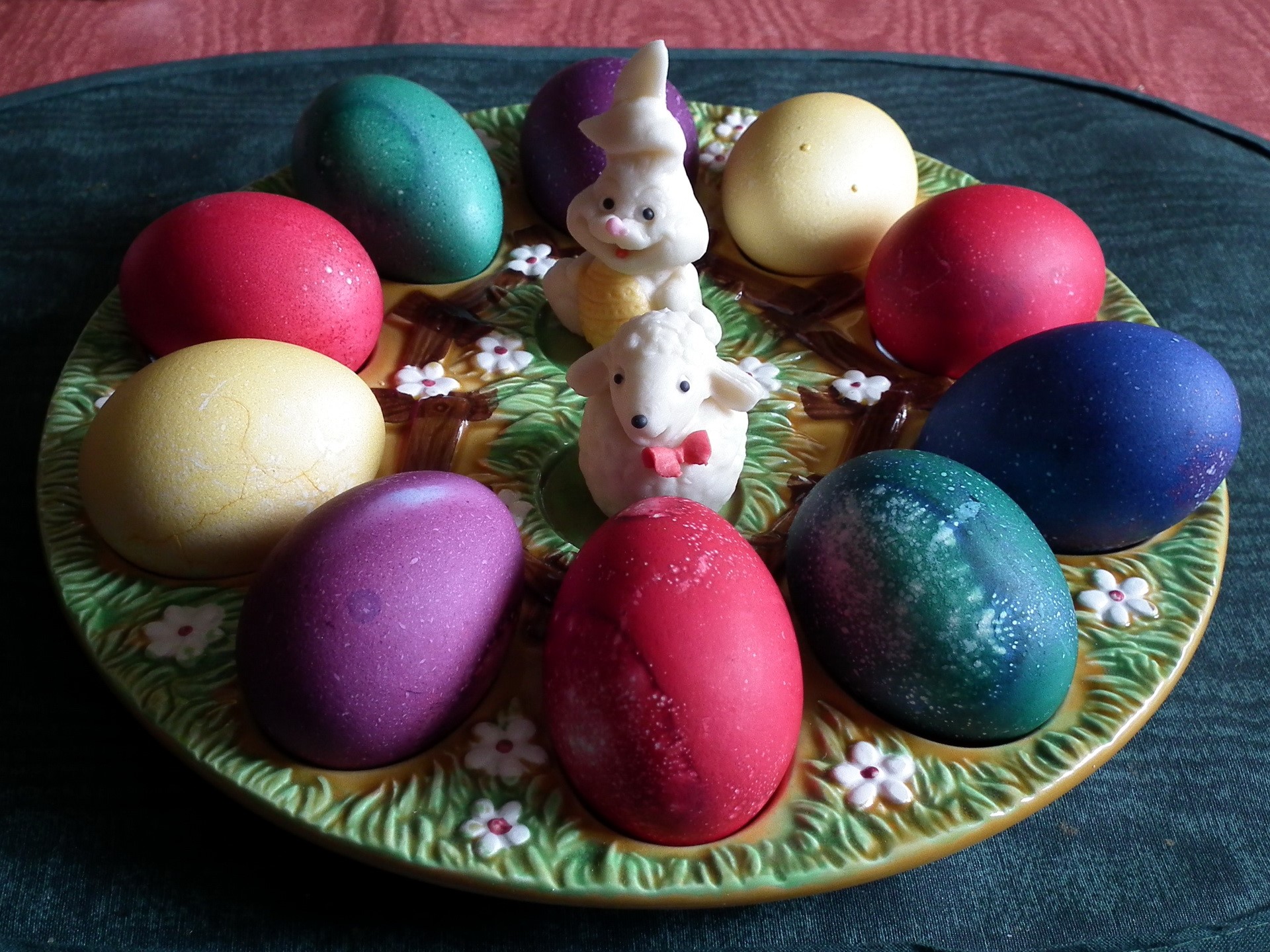 Easter eggs on a decorative plate with bunny and sheep figurines HD Wallpaper