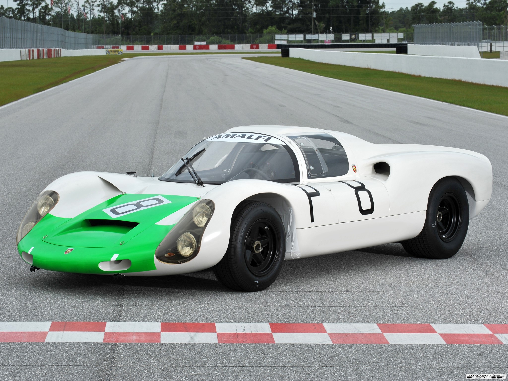 White and green Porsche race car on a track HD Wallpaper