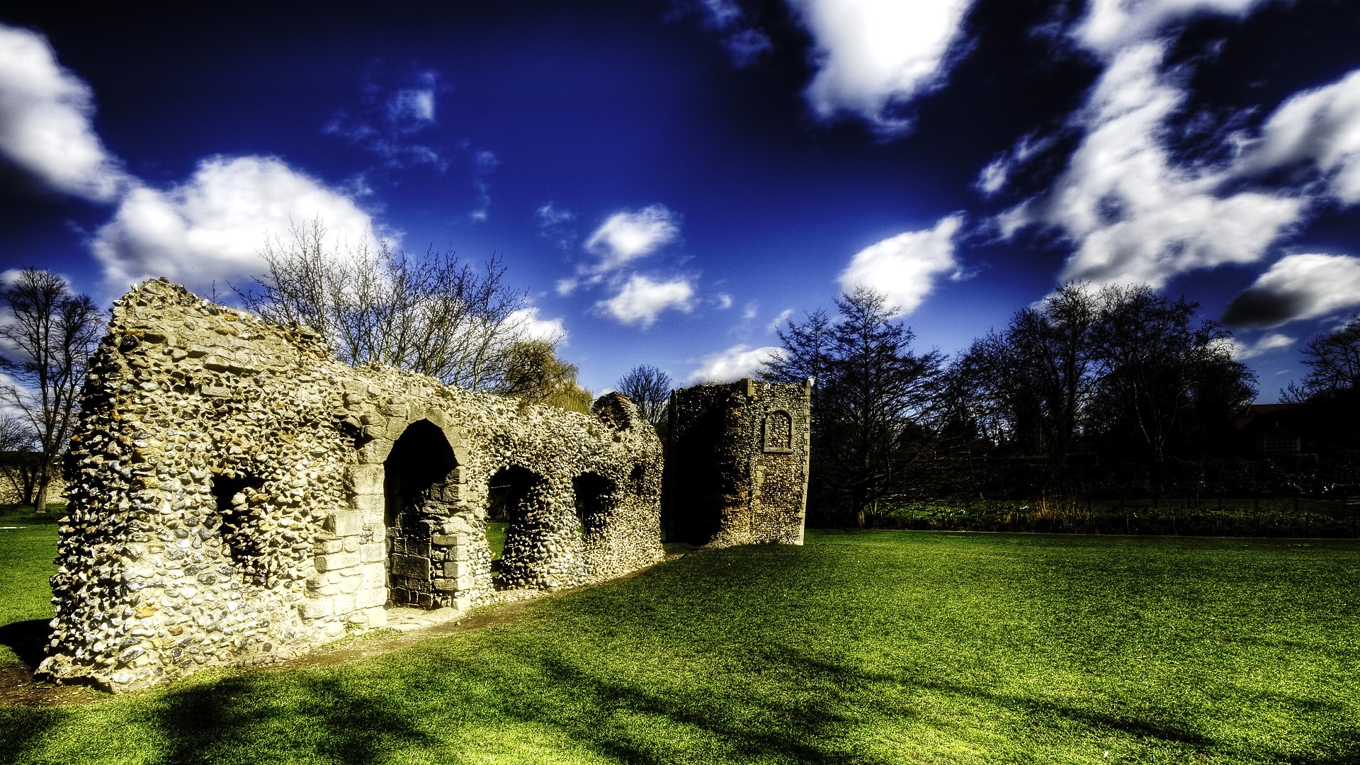 Ruins of an Abbey in a Grassy Field HD Wallpaper