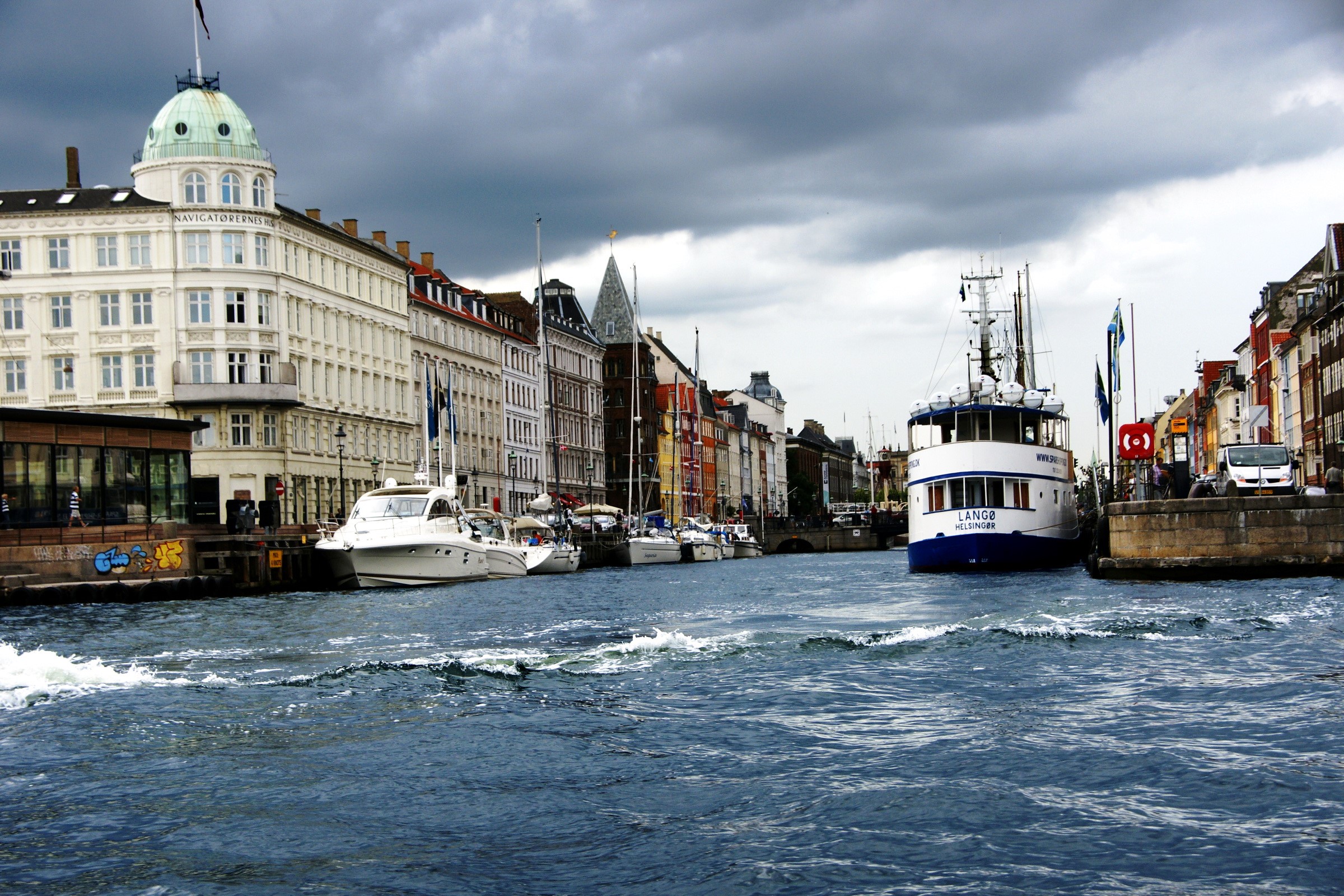 Canal in Copenhagen, Denmark with boats and buildings HD Wallpaper