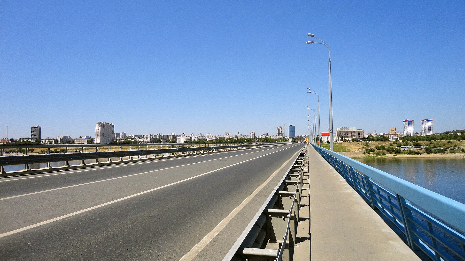 Bridge over river in Volgograd with city skyline HD Wallpaper