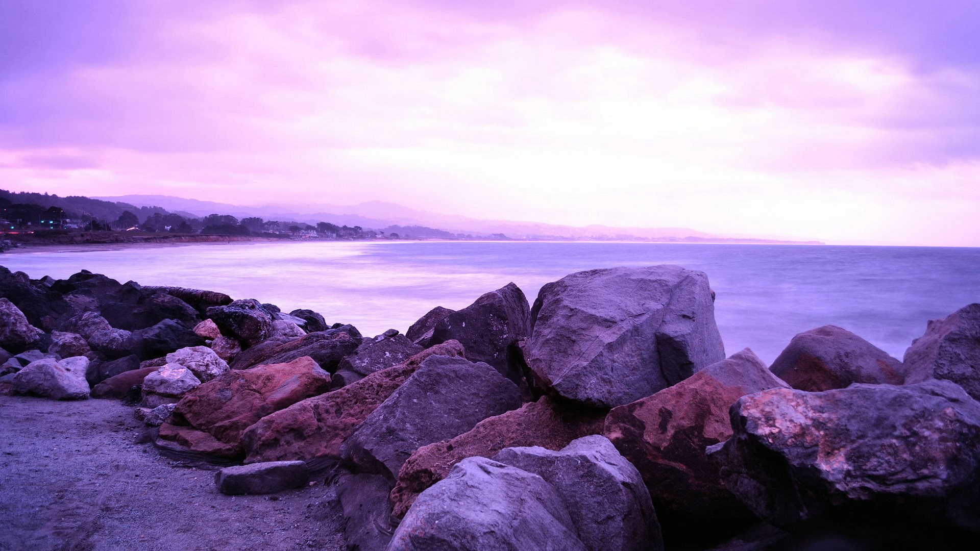 Purple sunset over a rocky coastline and ocean HD Wallpaper