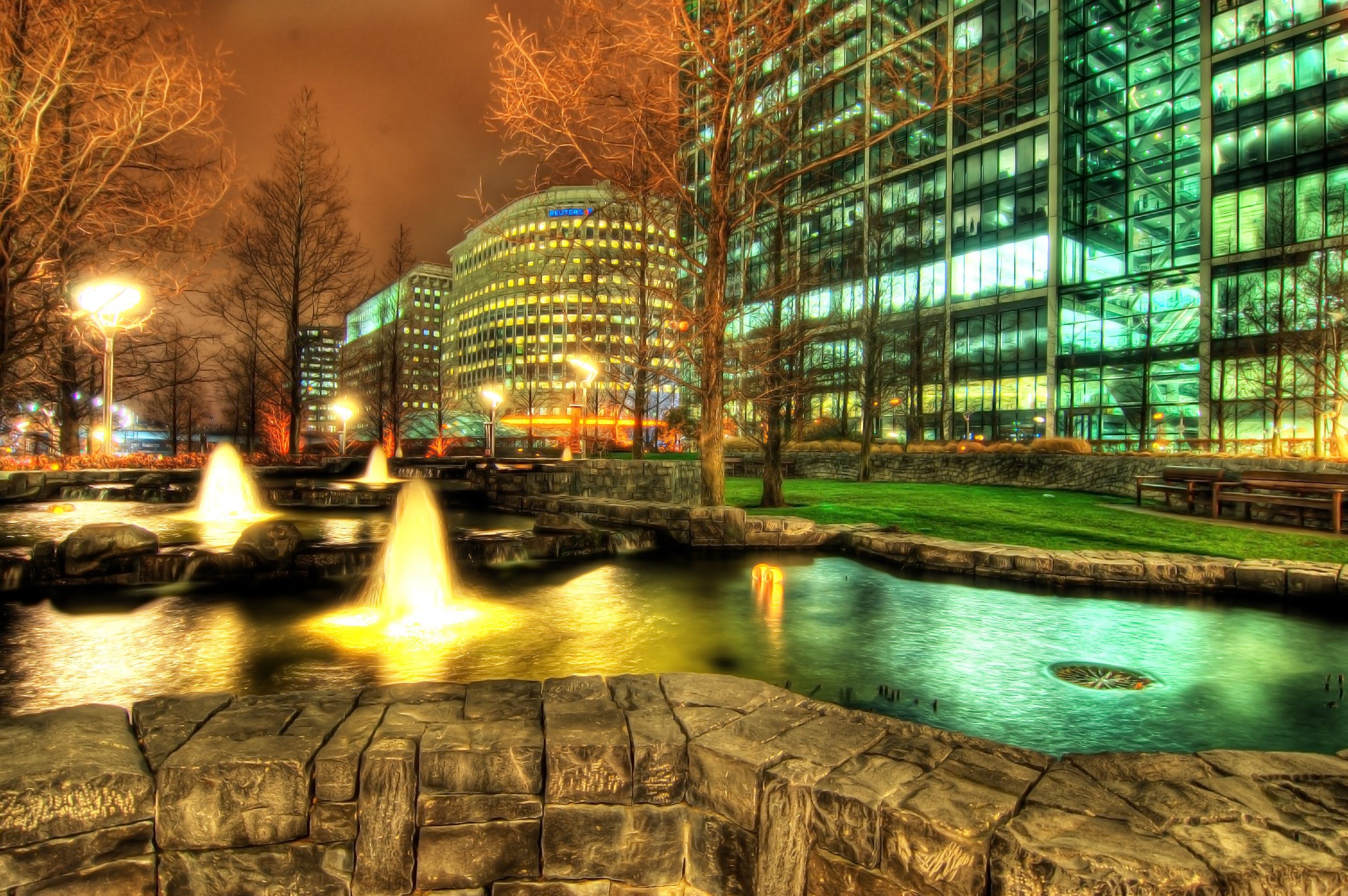 Fountains and modern buildings at night HD Wallpaper