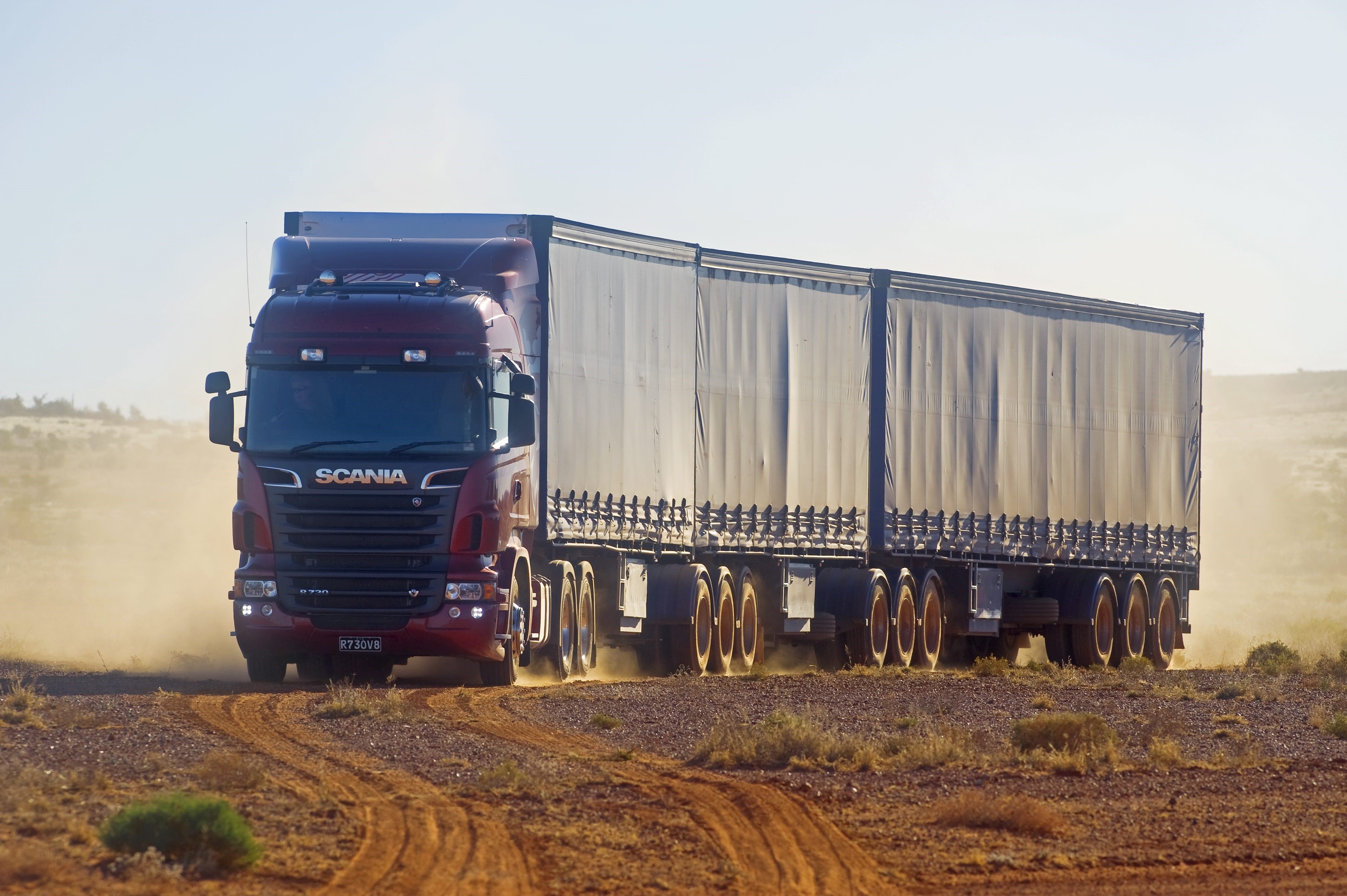 Scania truck driving on a dirt road HD Wallpaper