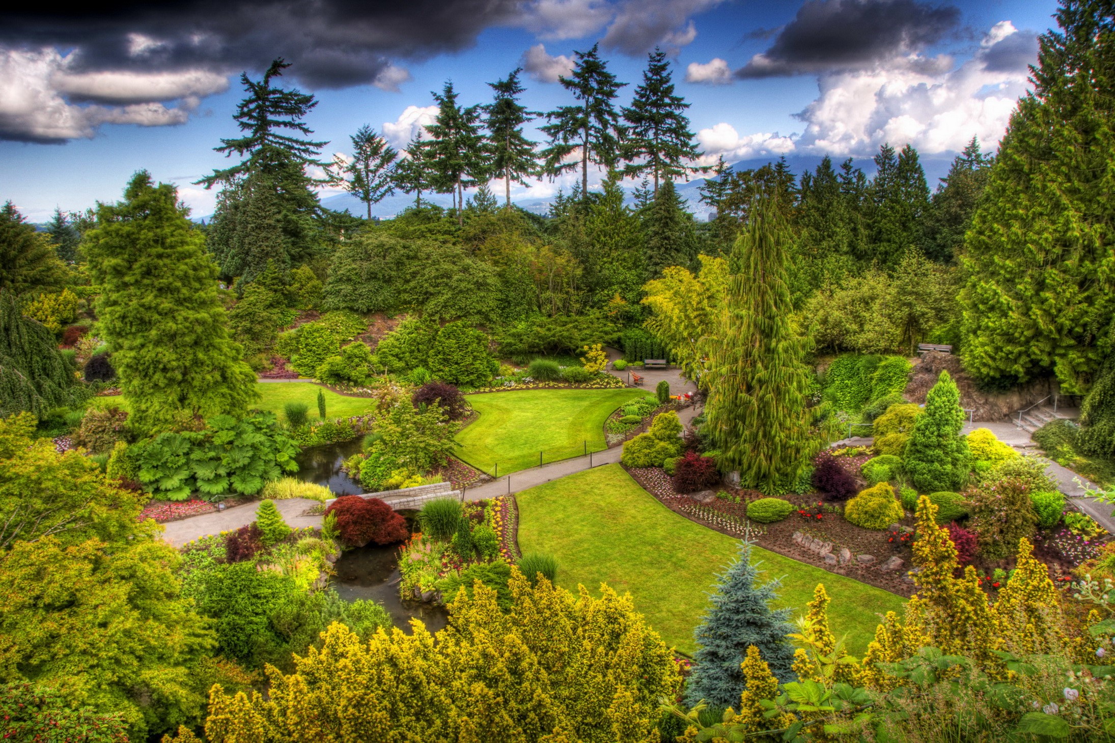 Beautiful botanical garden with winding paths and trees HD Wallpaper