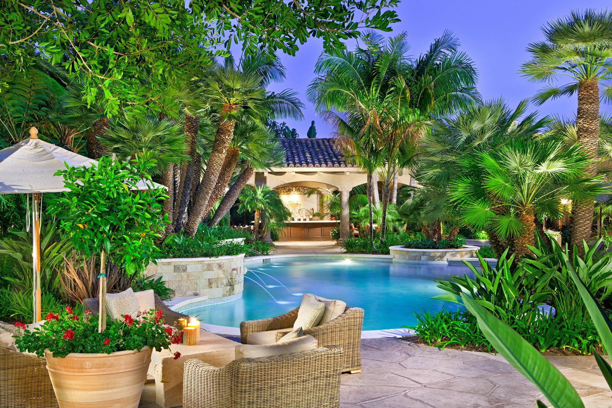 Tropical backyard pool with outdoor bar and seating HD Wallpaper