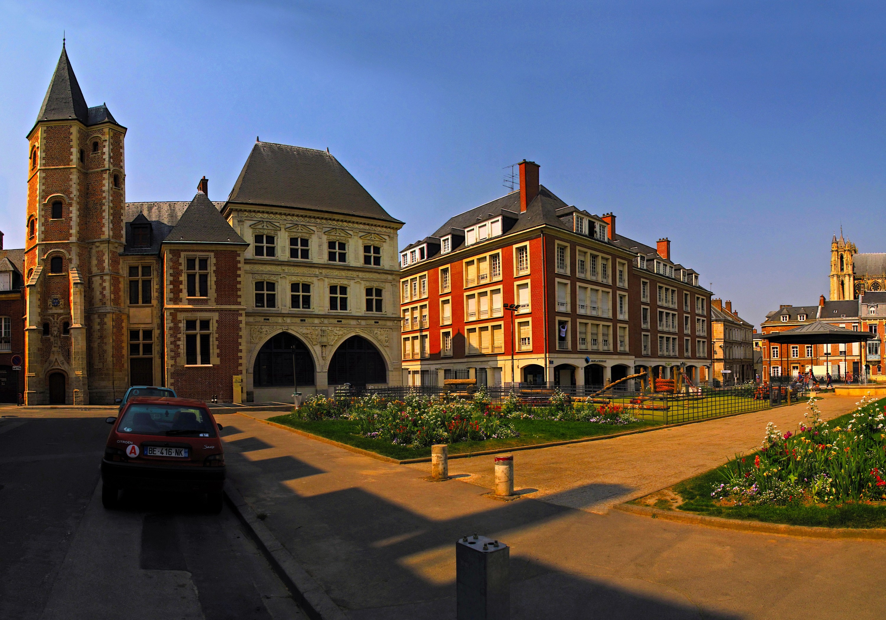 Town square with historic buildings and a park in France HD Wallpaper
