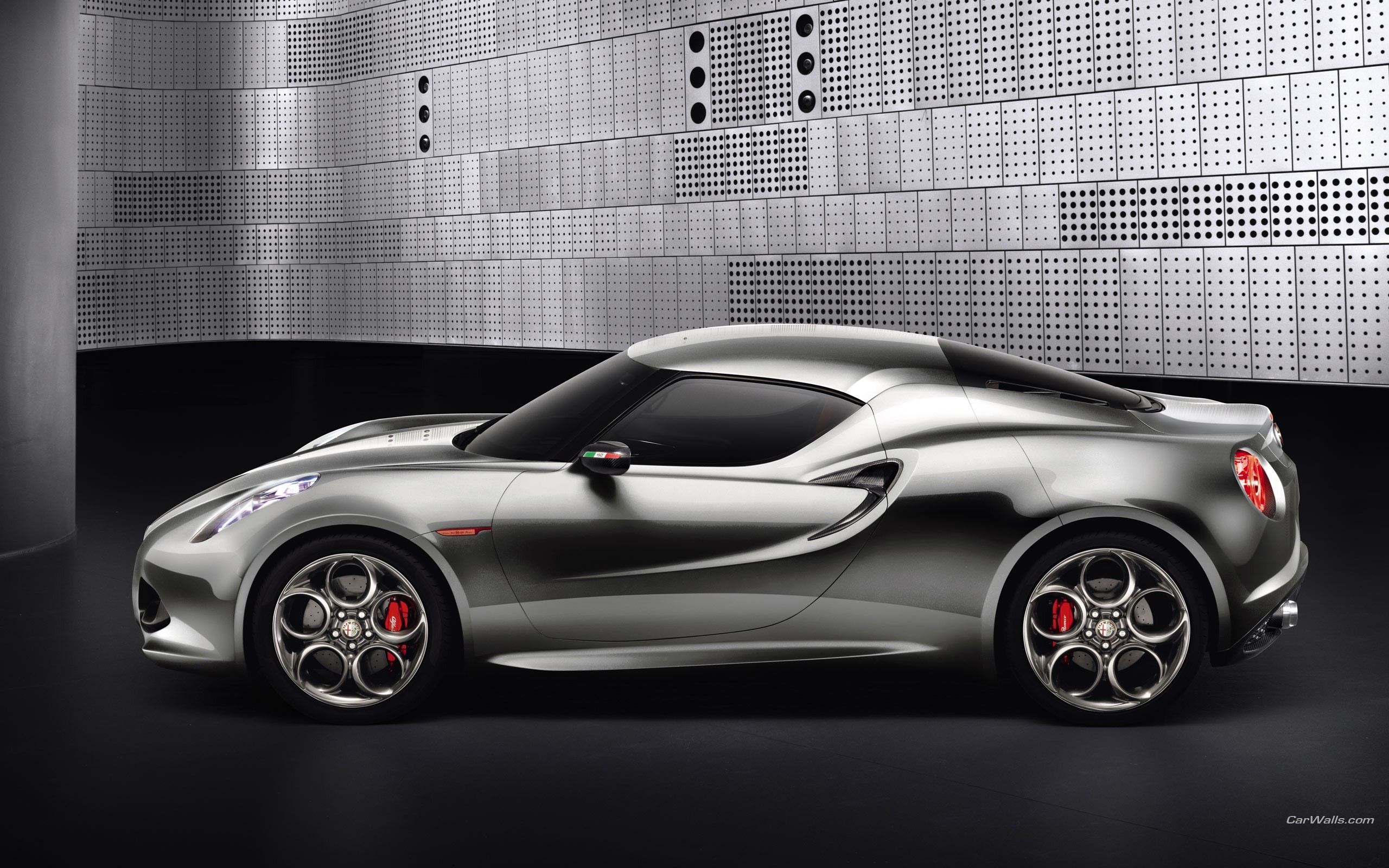 Silver Alfa Romeo 4C Spider parked in front of a metallic wall HD Wallpaper