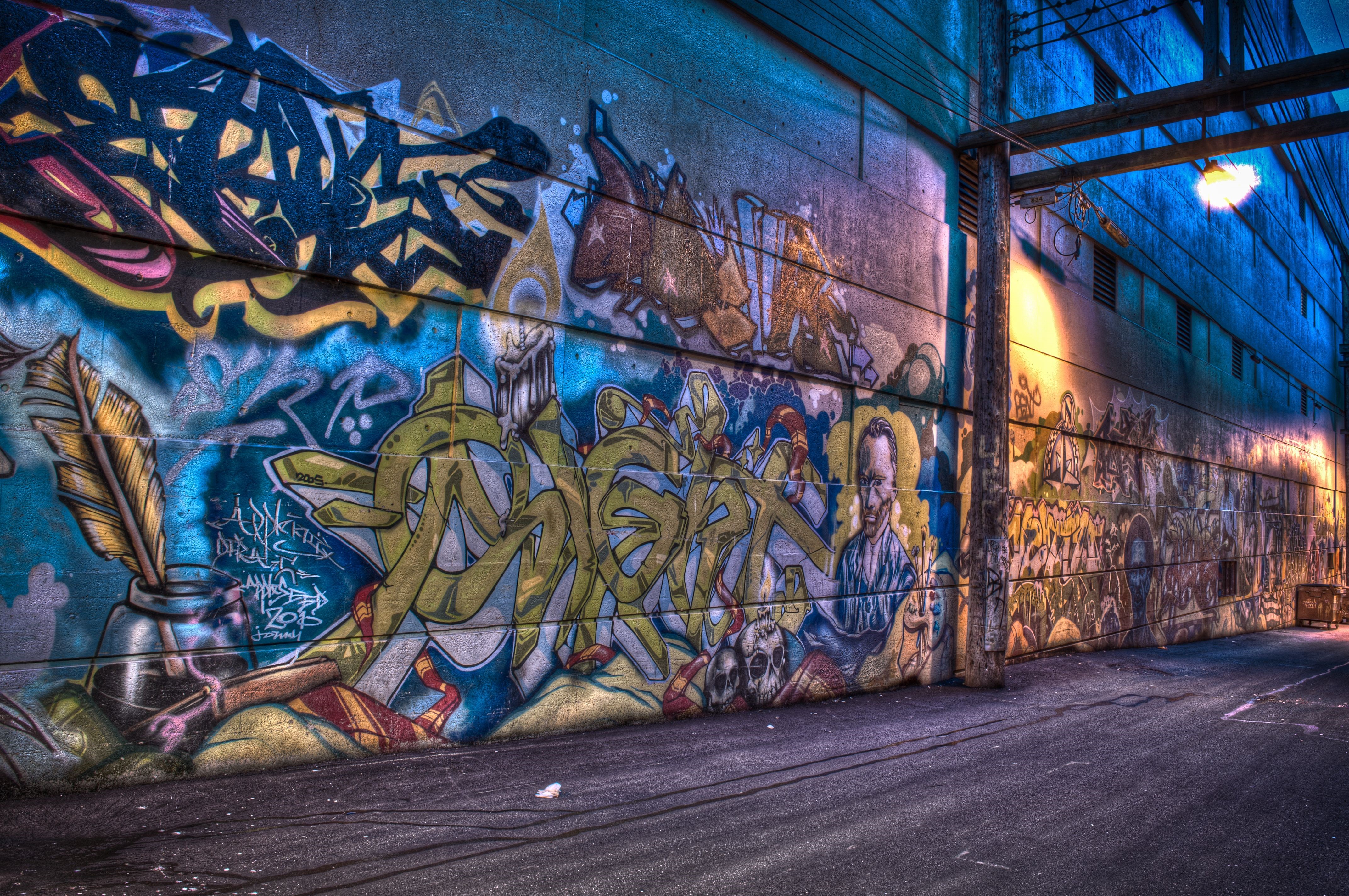 Graffiti alleyway with colorful murals HD Wallpaper