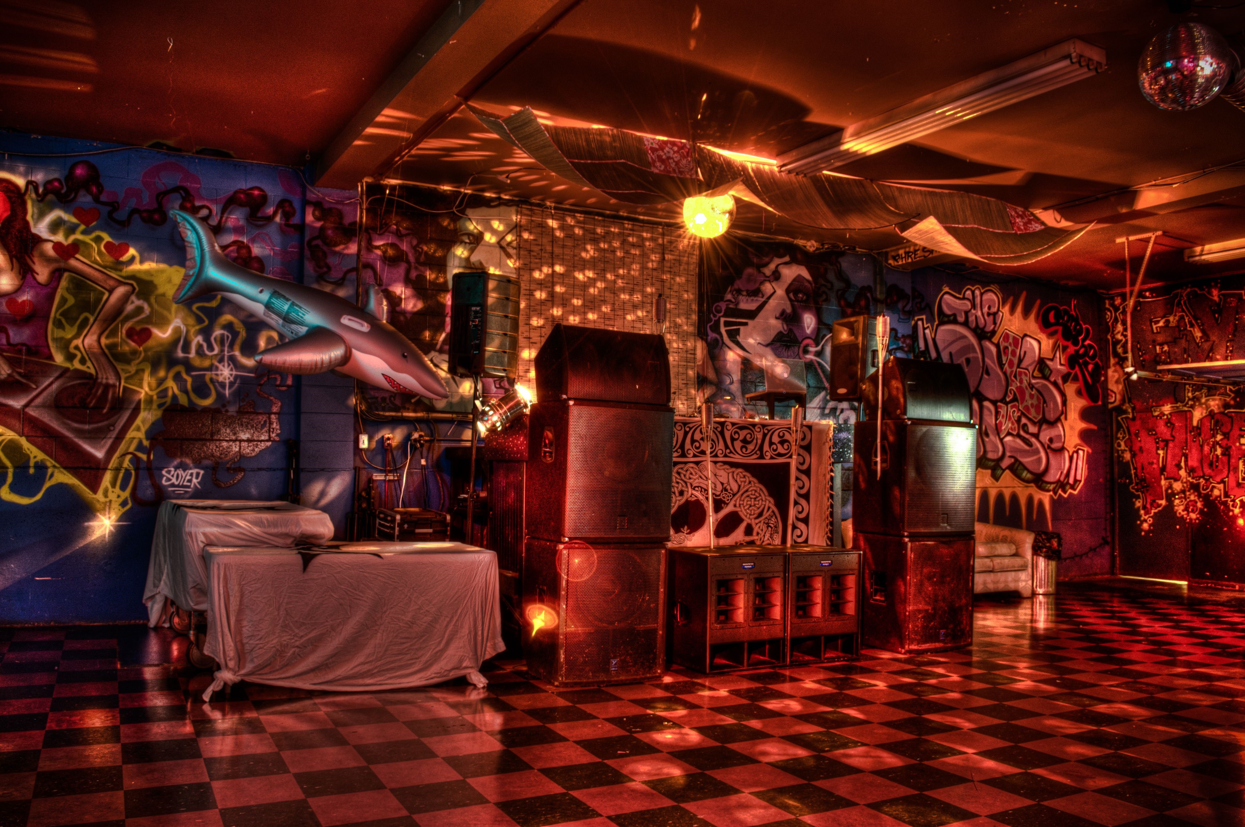 Graffiti-covered club interior with disco ball HD Wallpaper