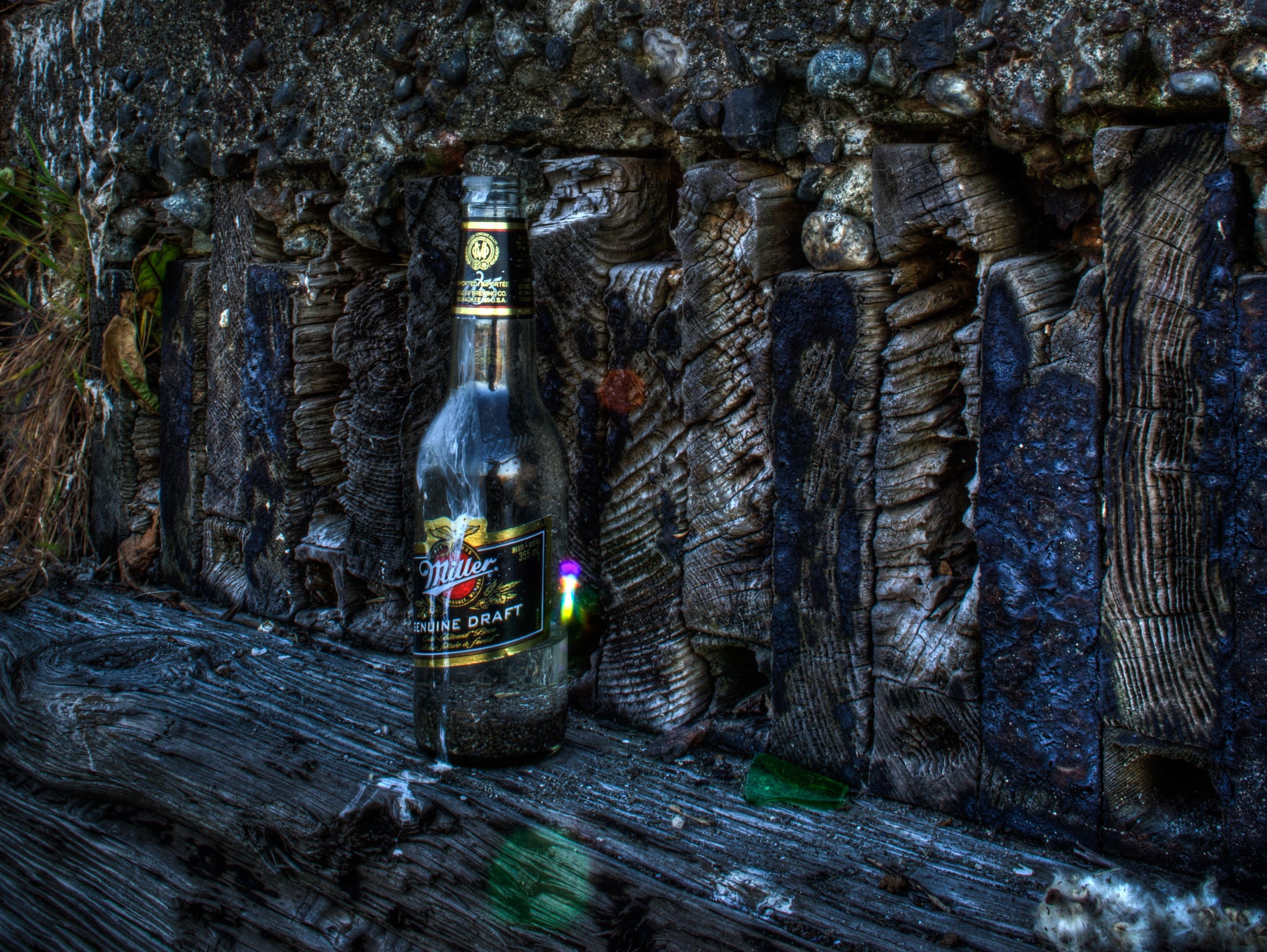 Miller Genuine Draft beer bottle on weathered wood HD Wallpaper
