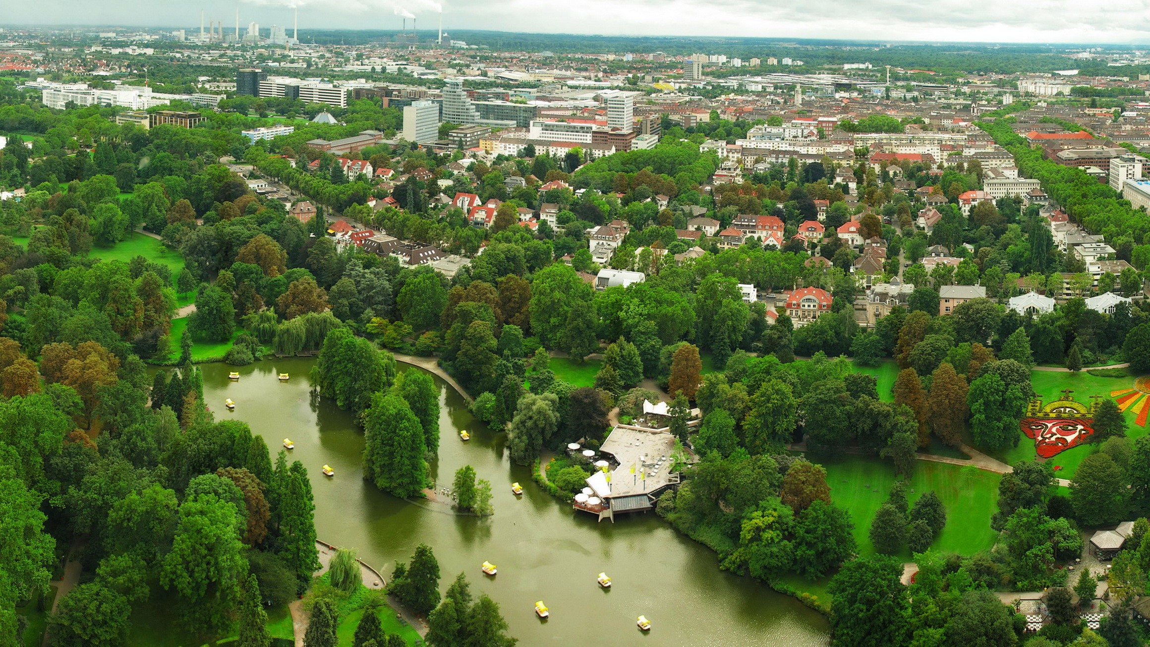 Aerial view of a park with a lake and city in Germany HD Wallpaper