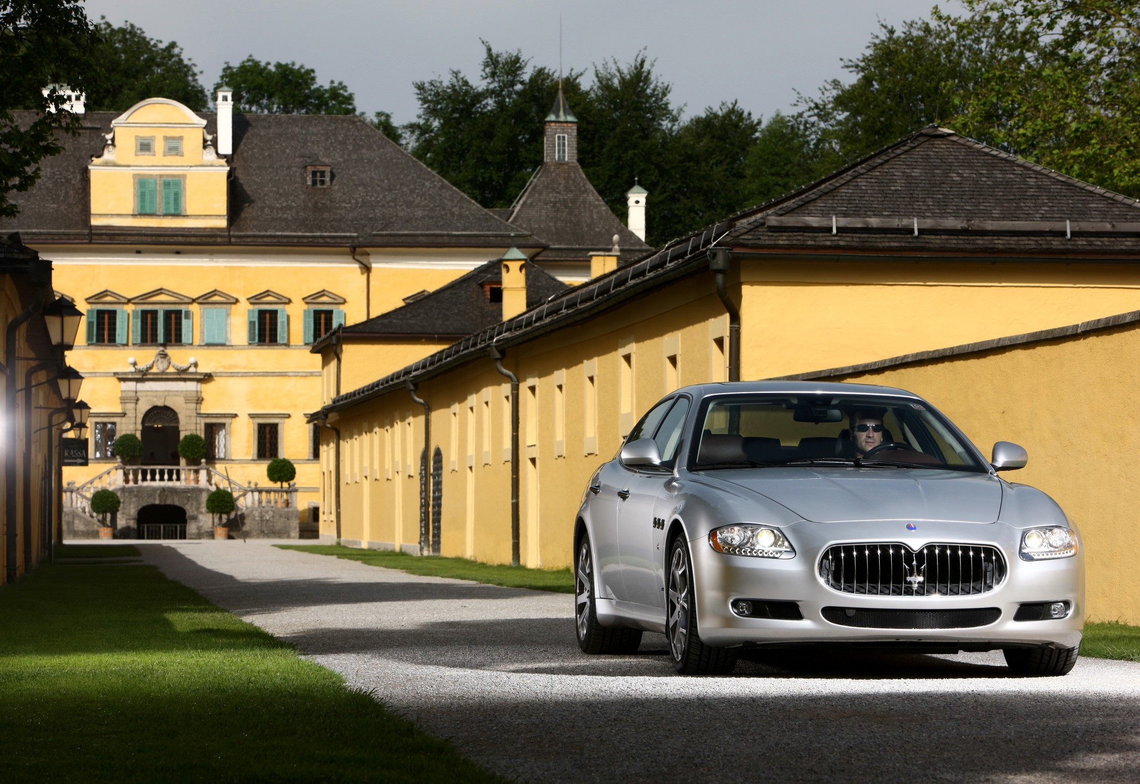 Maserati Quattroporte S in front of a yellow building HD Wallpaper