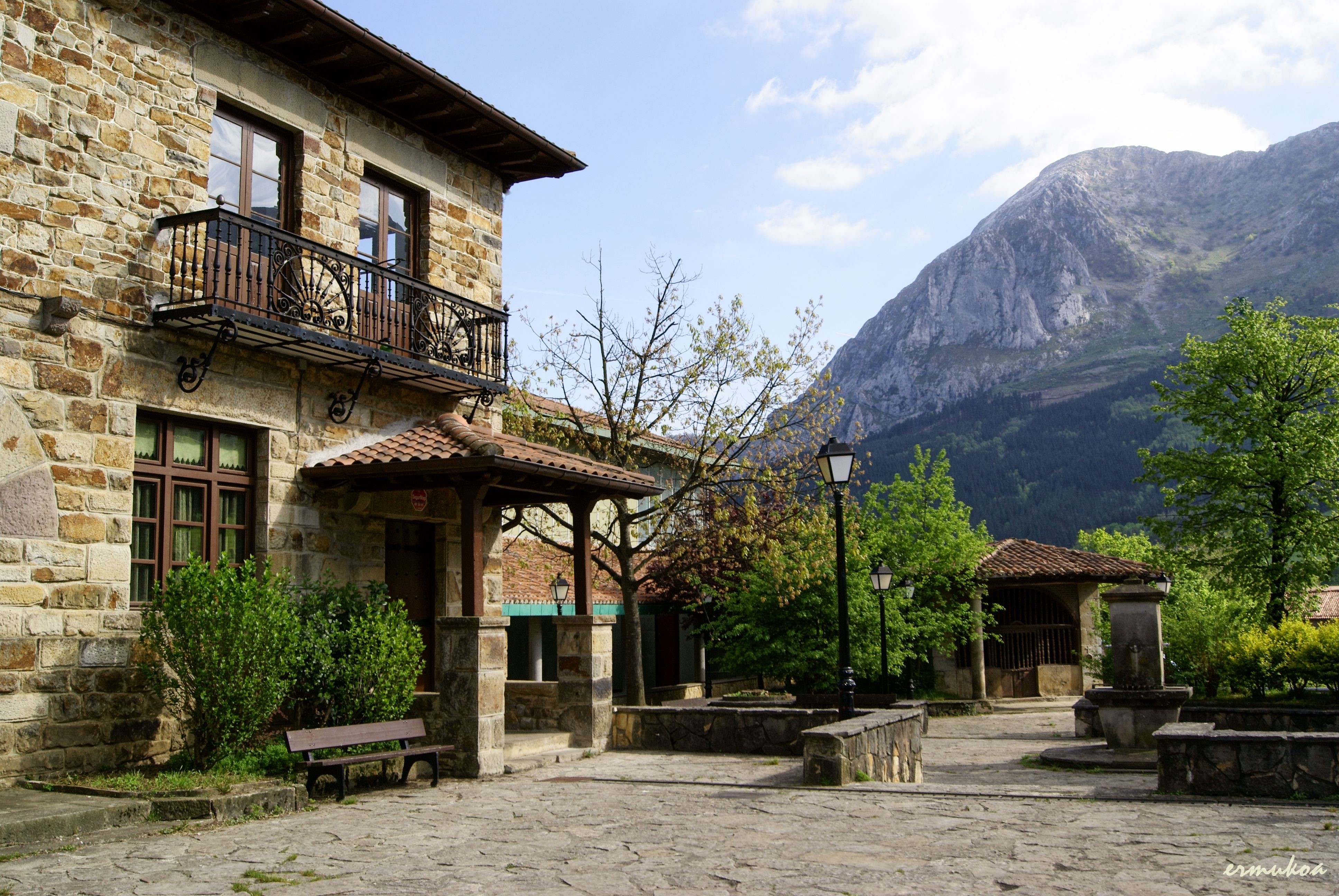 Stone building with balcony and mountain in Spain HD Wallpaper