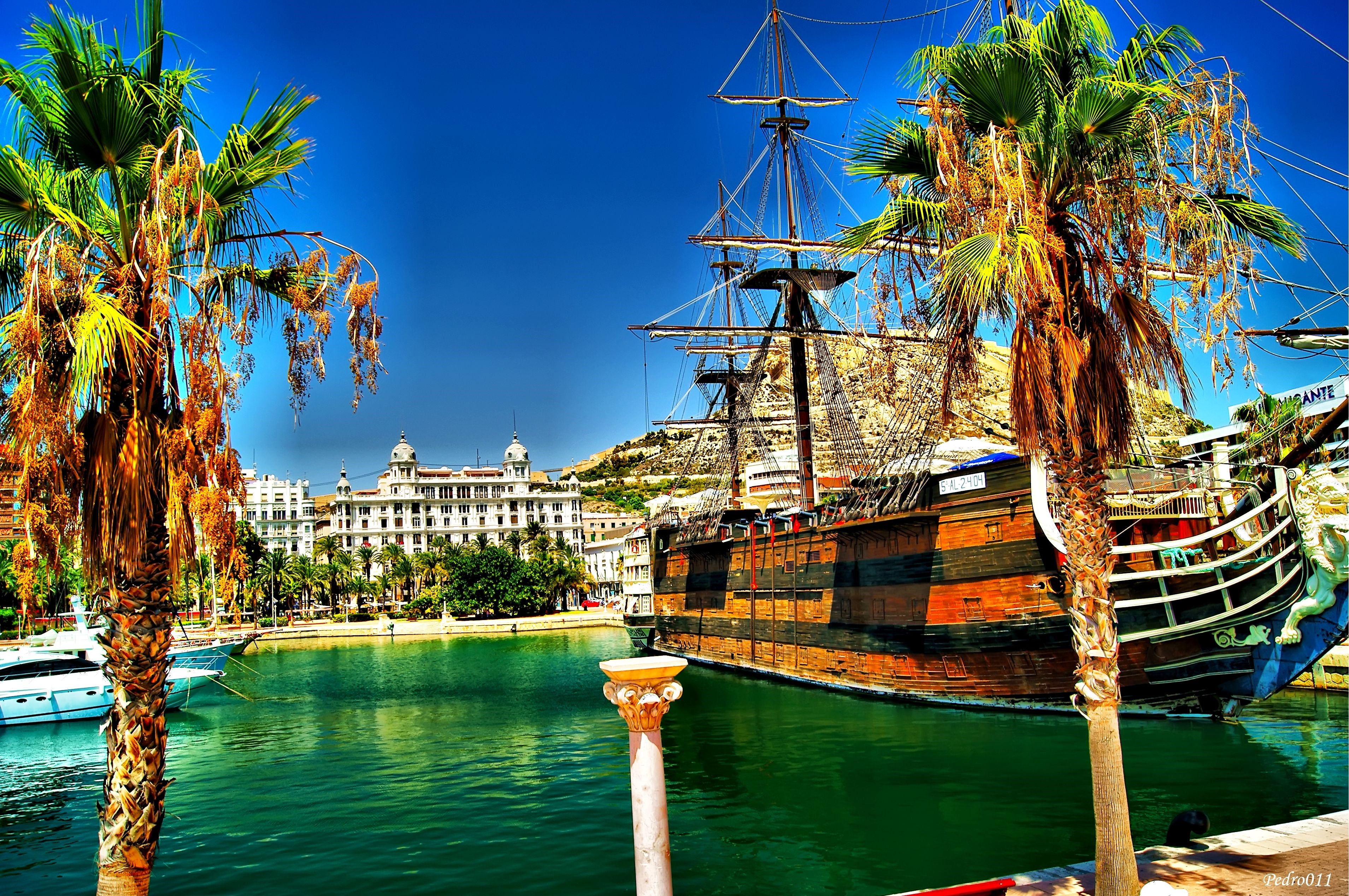 Replica Holy Trinity ship in a harbor with palm trees HD Wallpaper