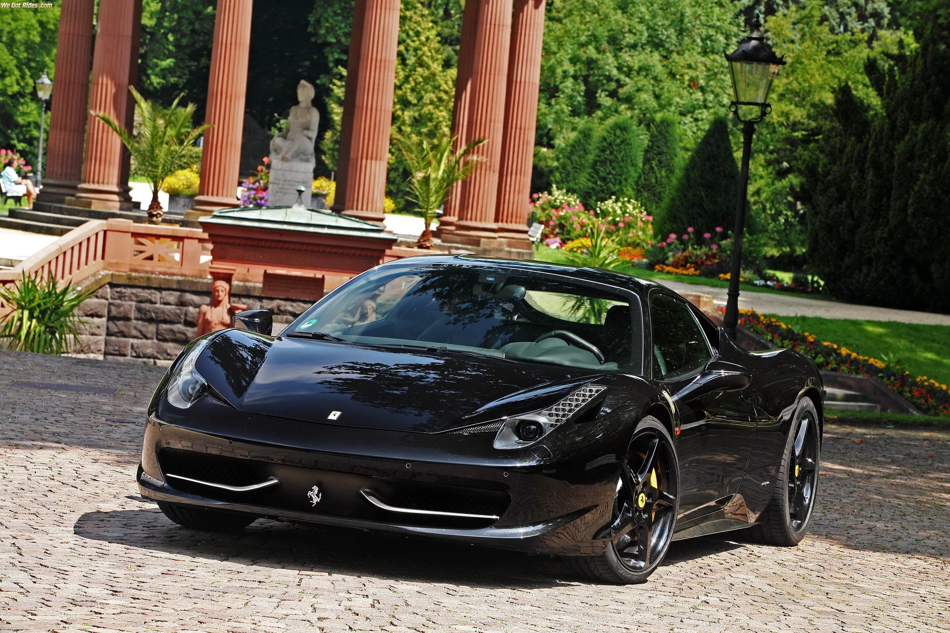 Black Ferrari parked in front of a building with columns HD Wallpaper