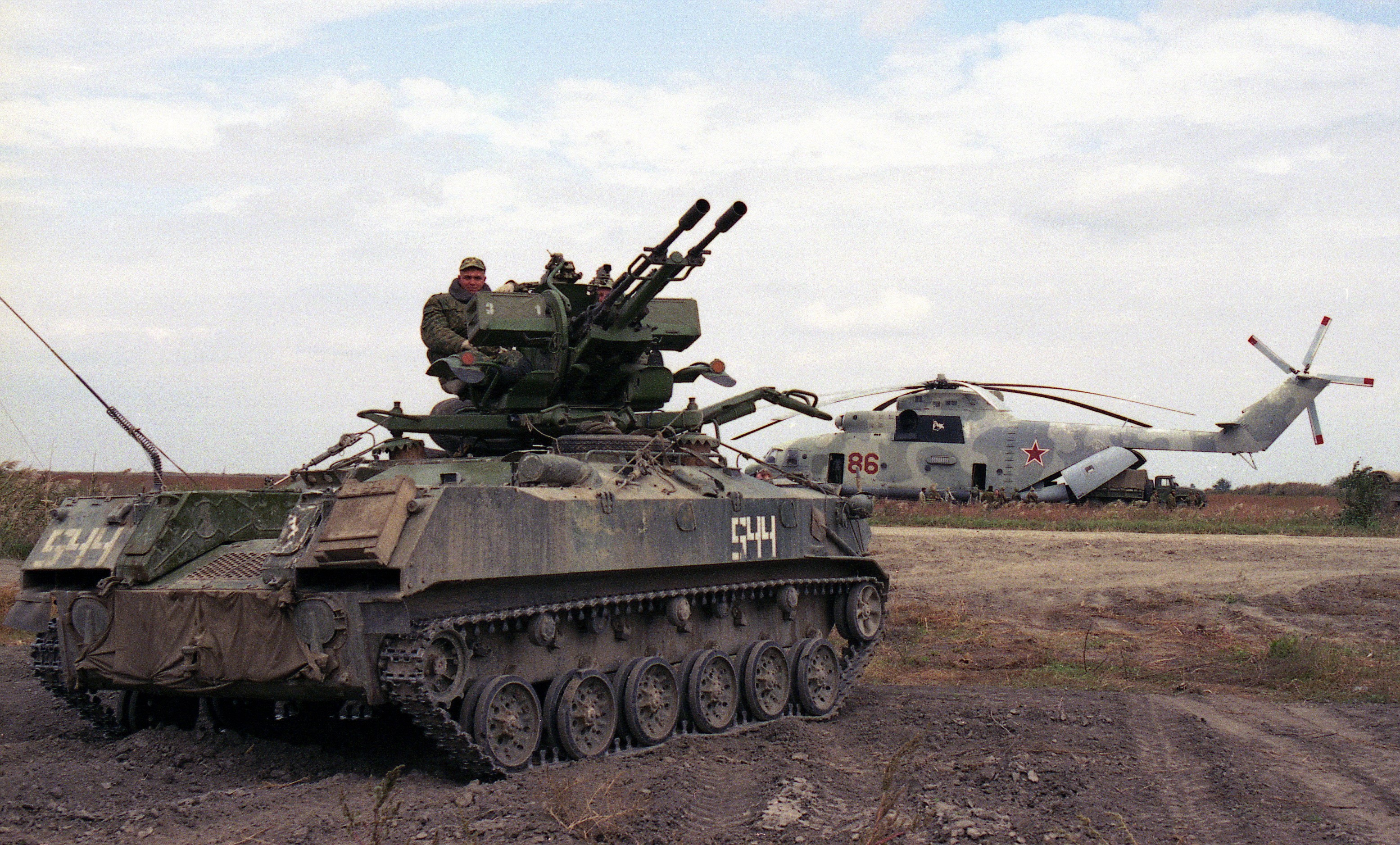 Armored vehicle with anti-aircraft guns and helicopter HD Wallpaper