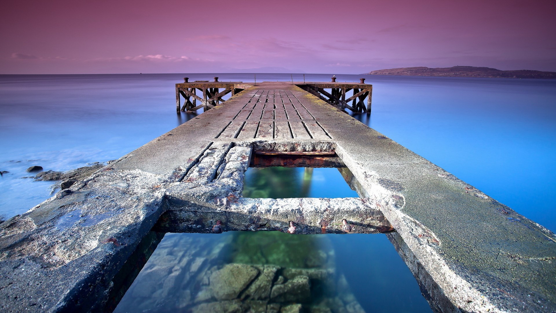 Old wooden pier over calm water at sunset HD Wallpaper