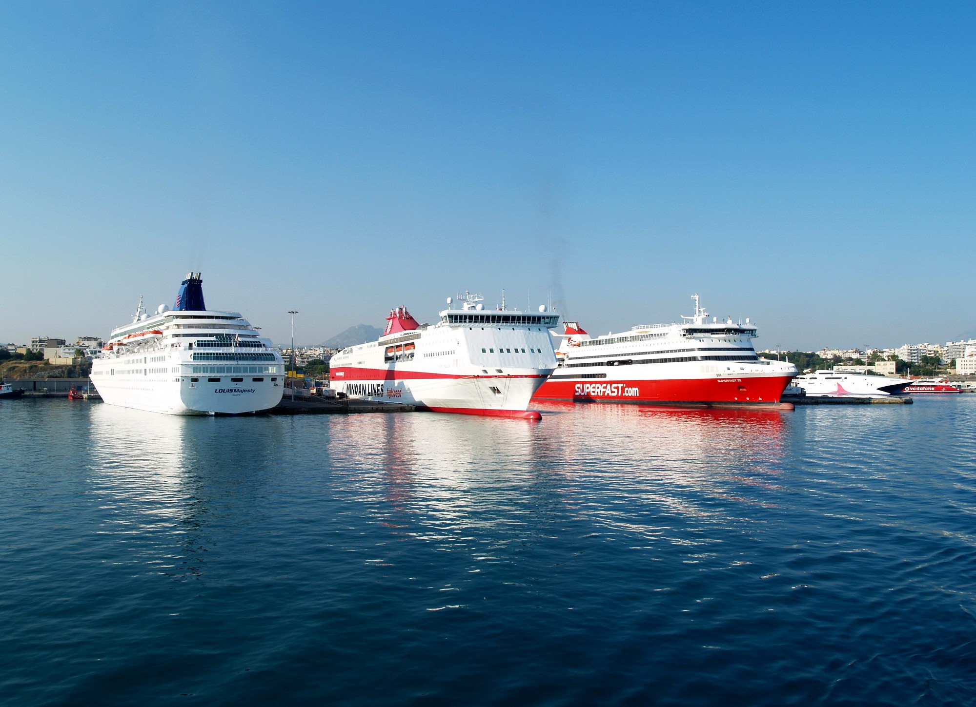 Ferries docked in a harbor under a clear blue sky HD Wallpaper
