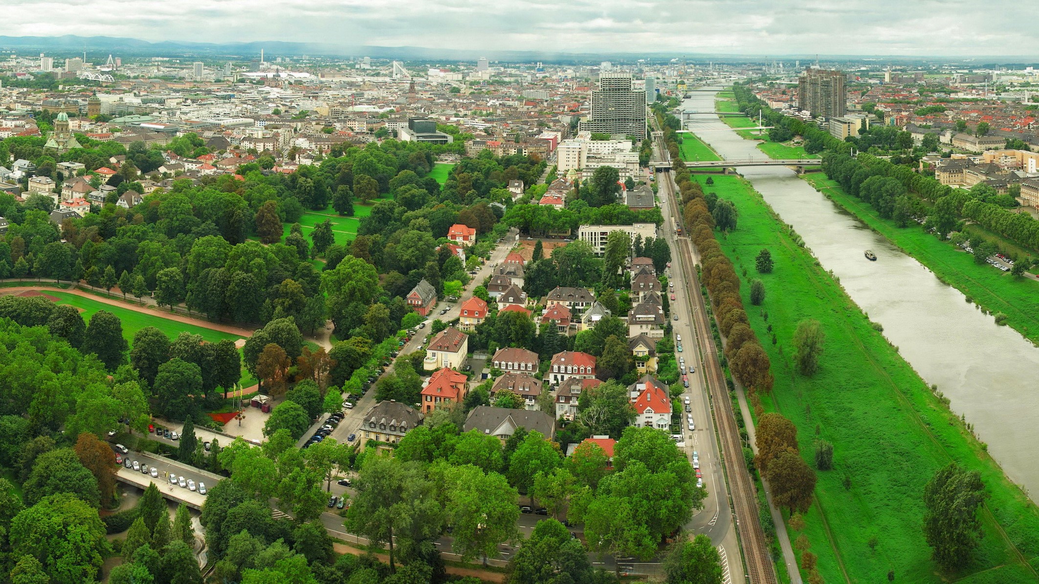 Aerial view of a German city with a river and park HD Wallpaper