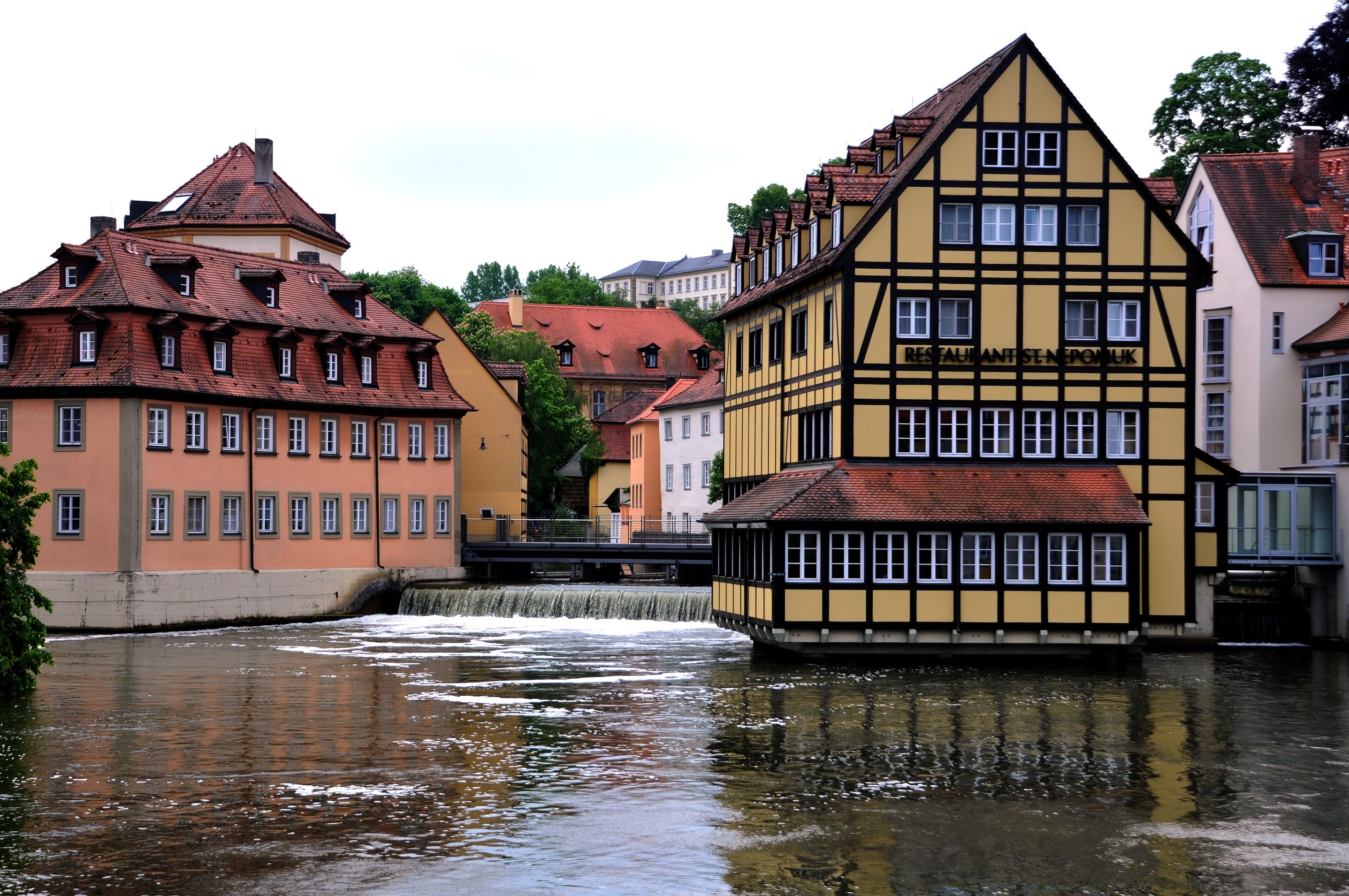 Half-timbered buildings along a river in Germany HD Wallpaper