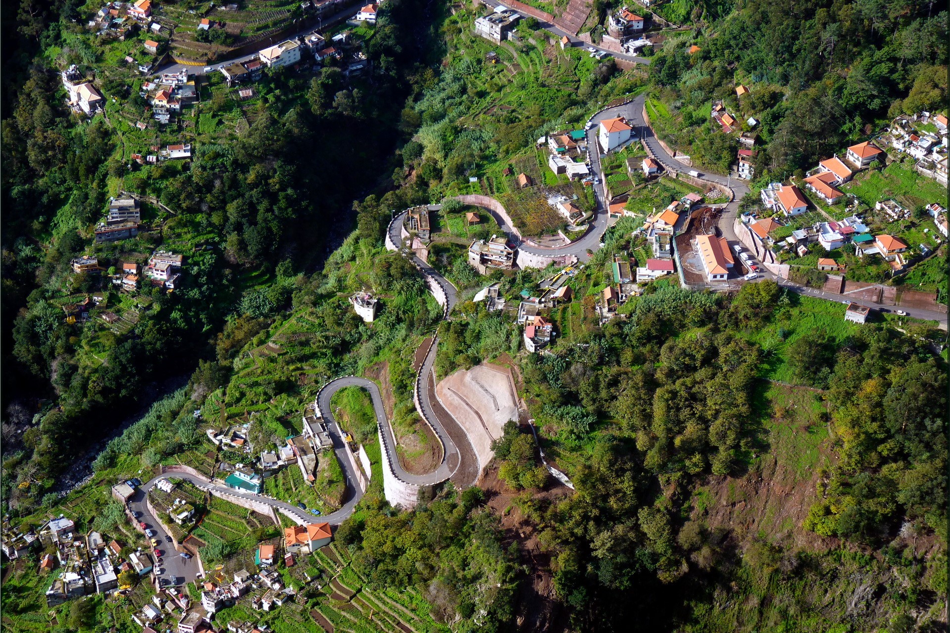 Aerial view of a winding road and village in Portugal HD Wallpaper