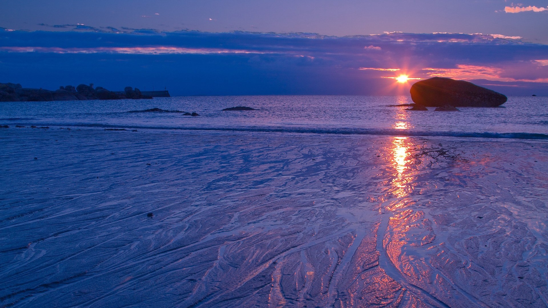 Sunset over the ocean with a large rock HD Wallpaper