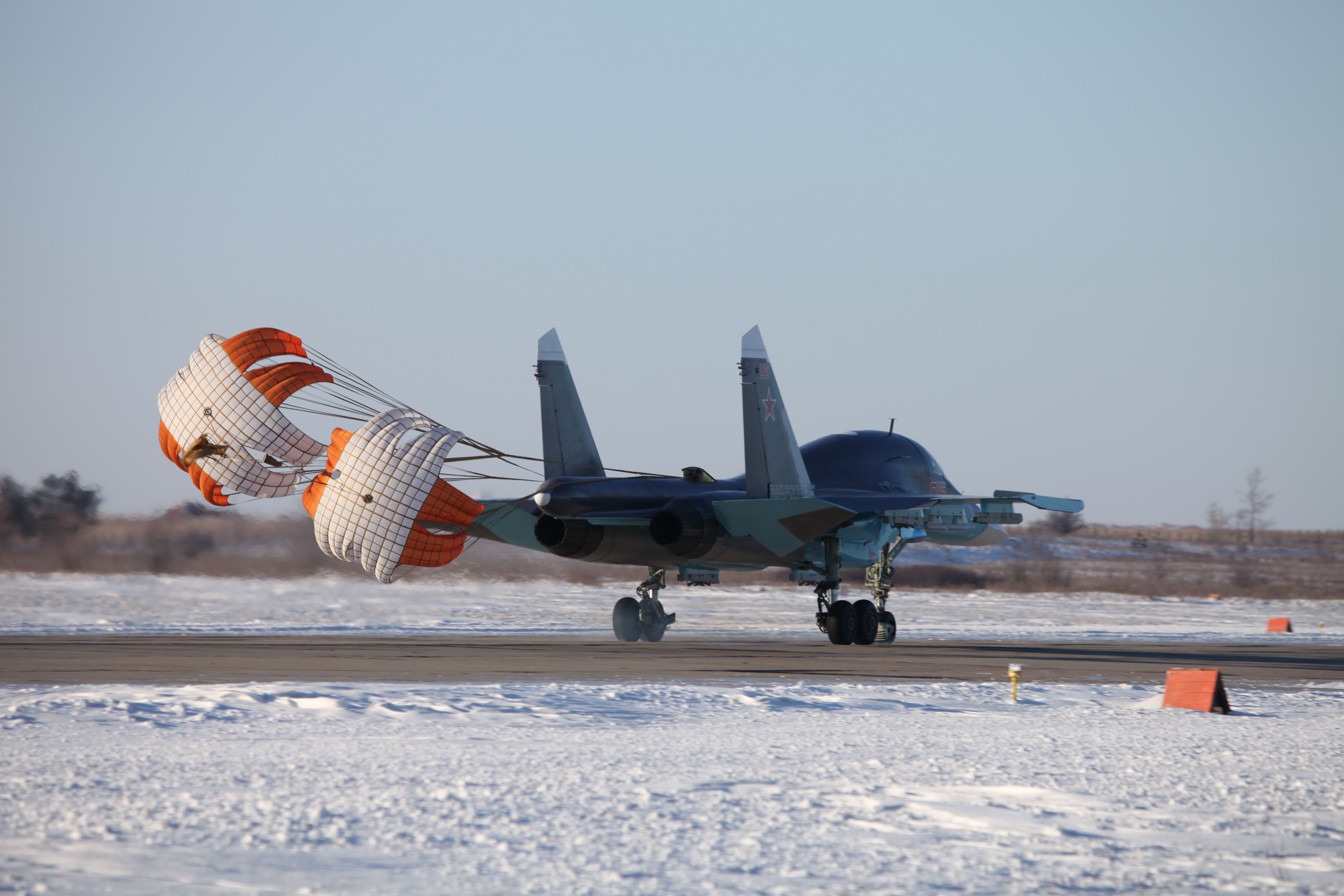 Airplane with drag parachute on runway HD Wallpaper