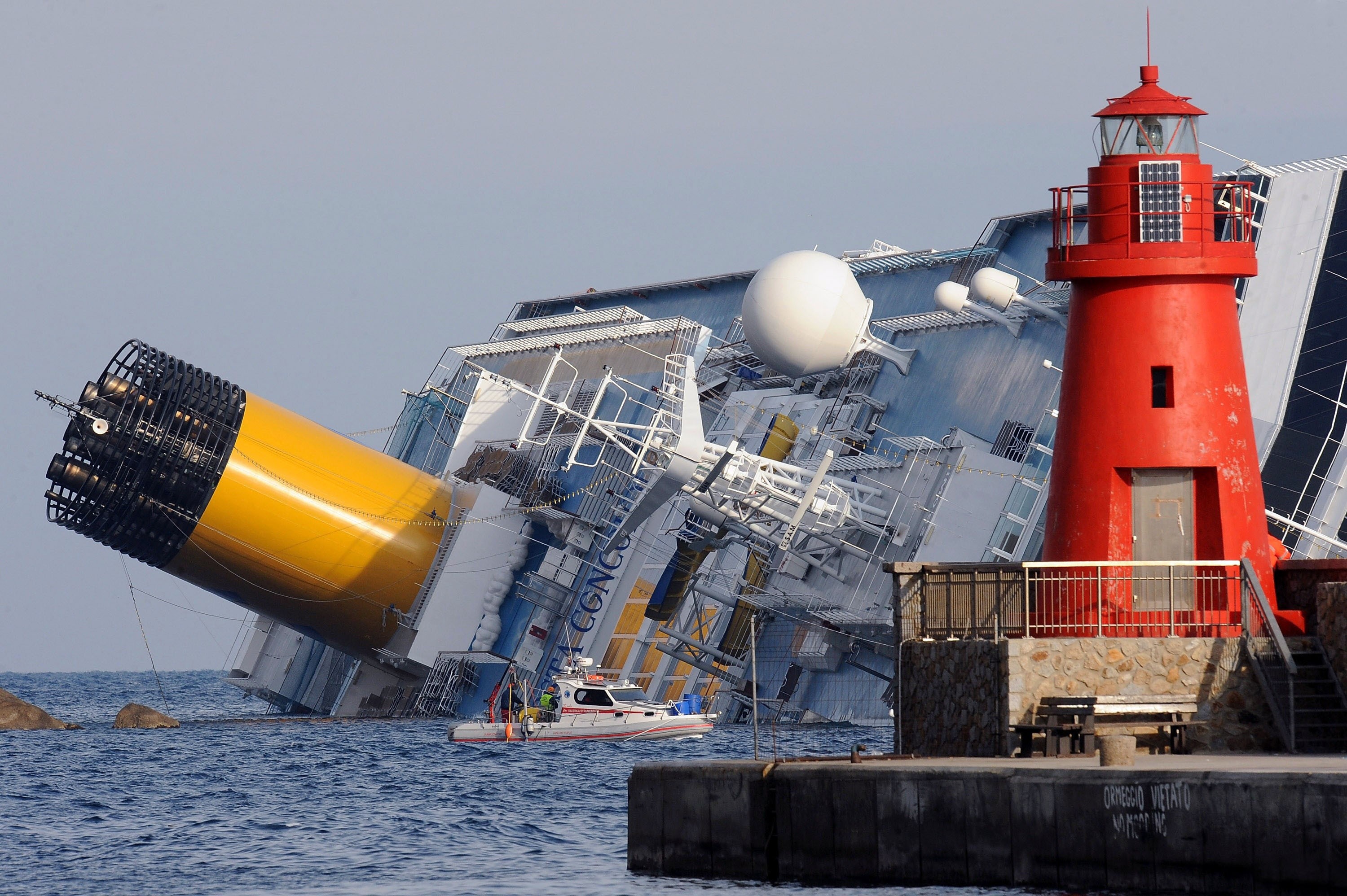 Costa Concordia cruise ship capsized near a lighthouse HD Wallpaper