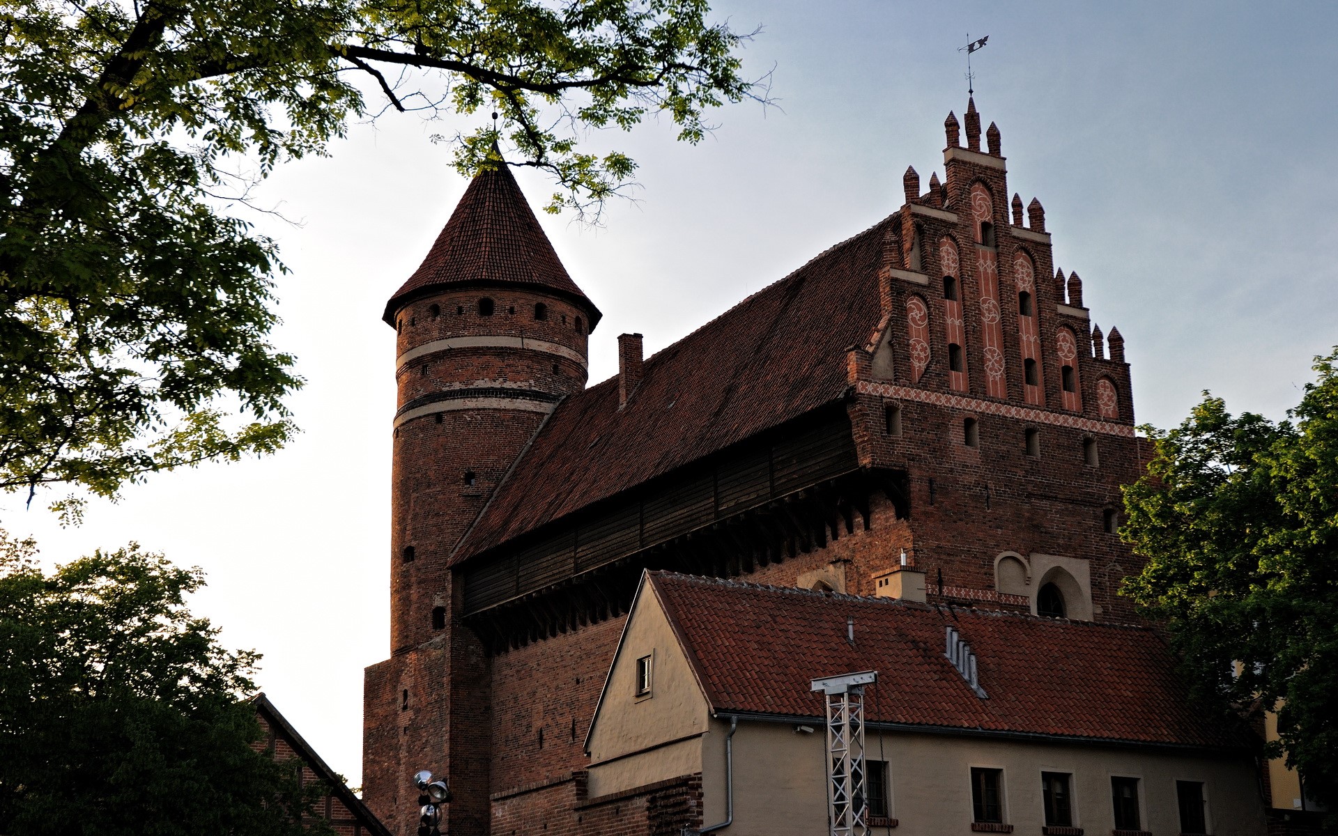 Brick castle with a round tower and trees HD Wallpaper