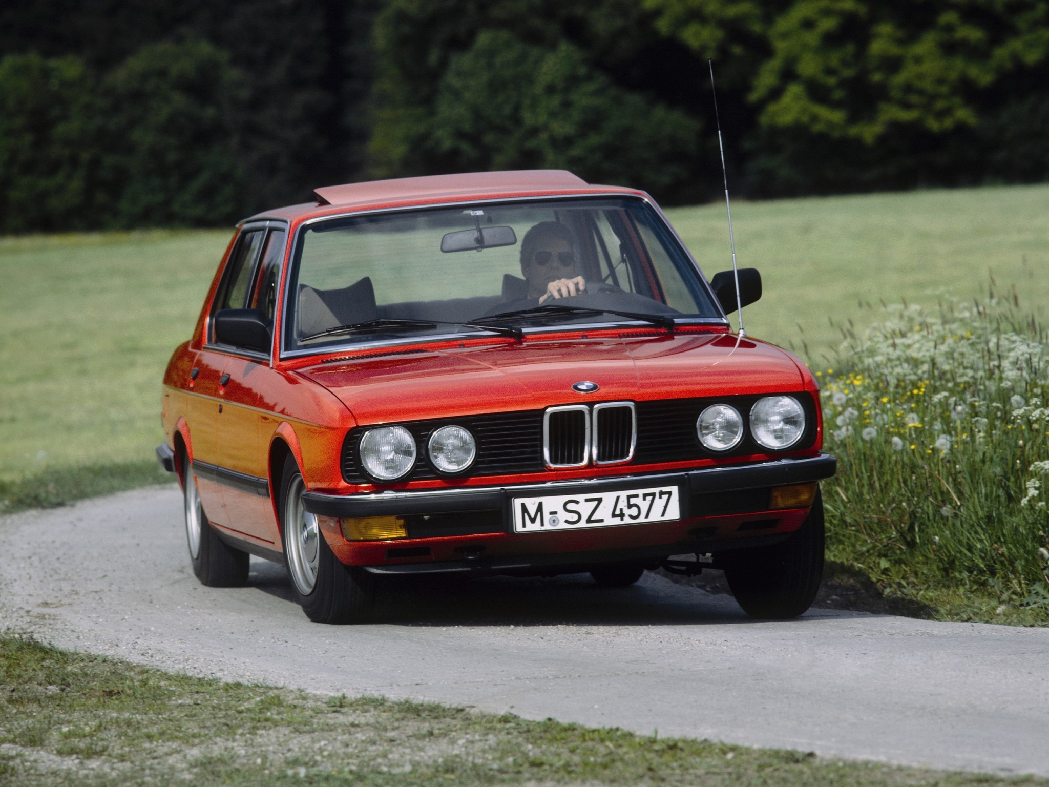 Red BMW Sedan on a Country Road HD Wallpaper