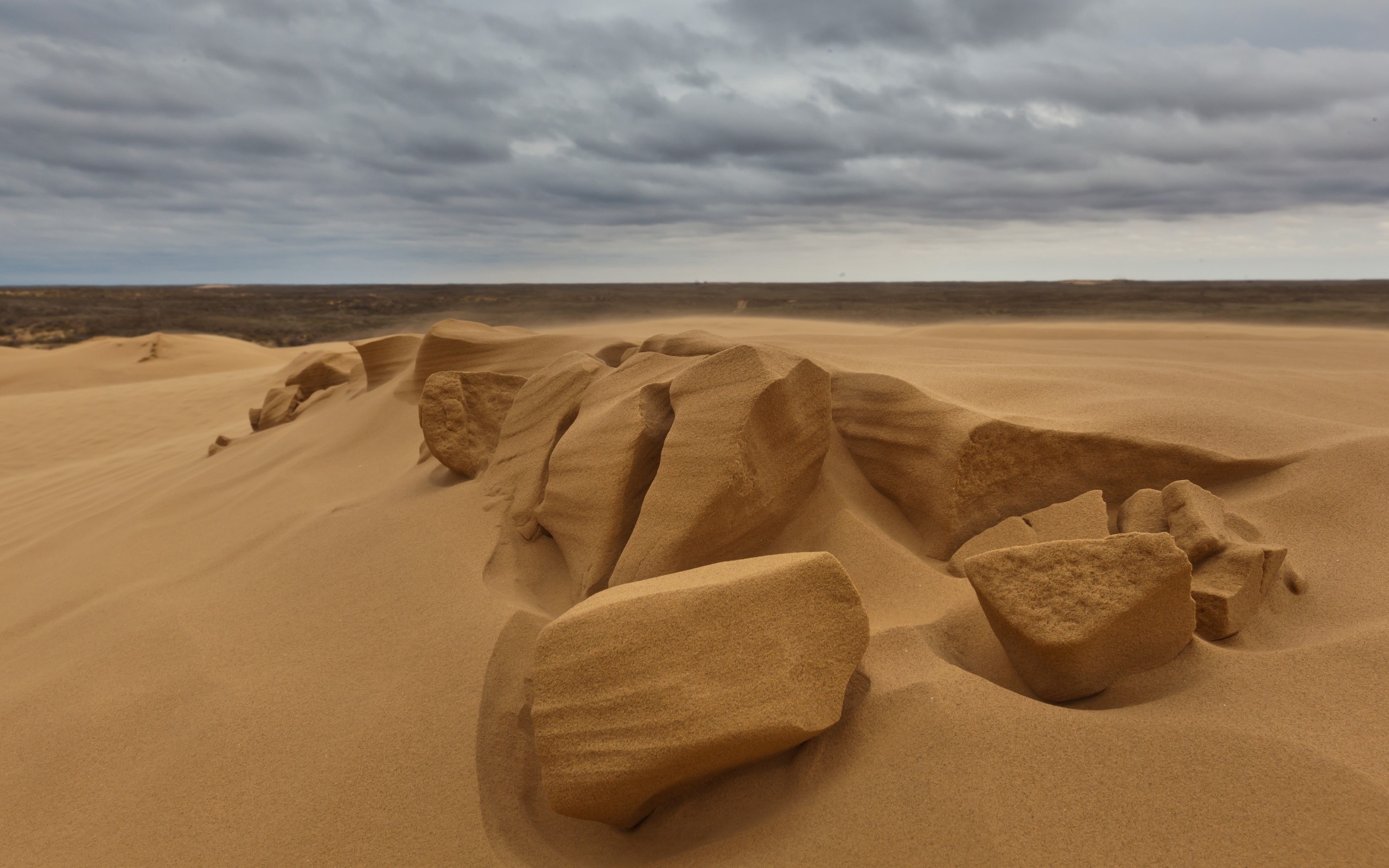 Sand dunes and rocks in a desert landscape HD Wallpaper