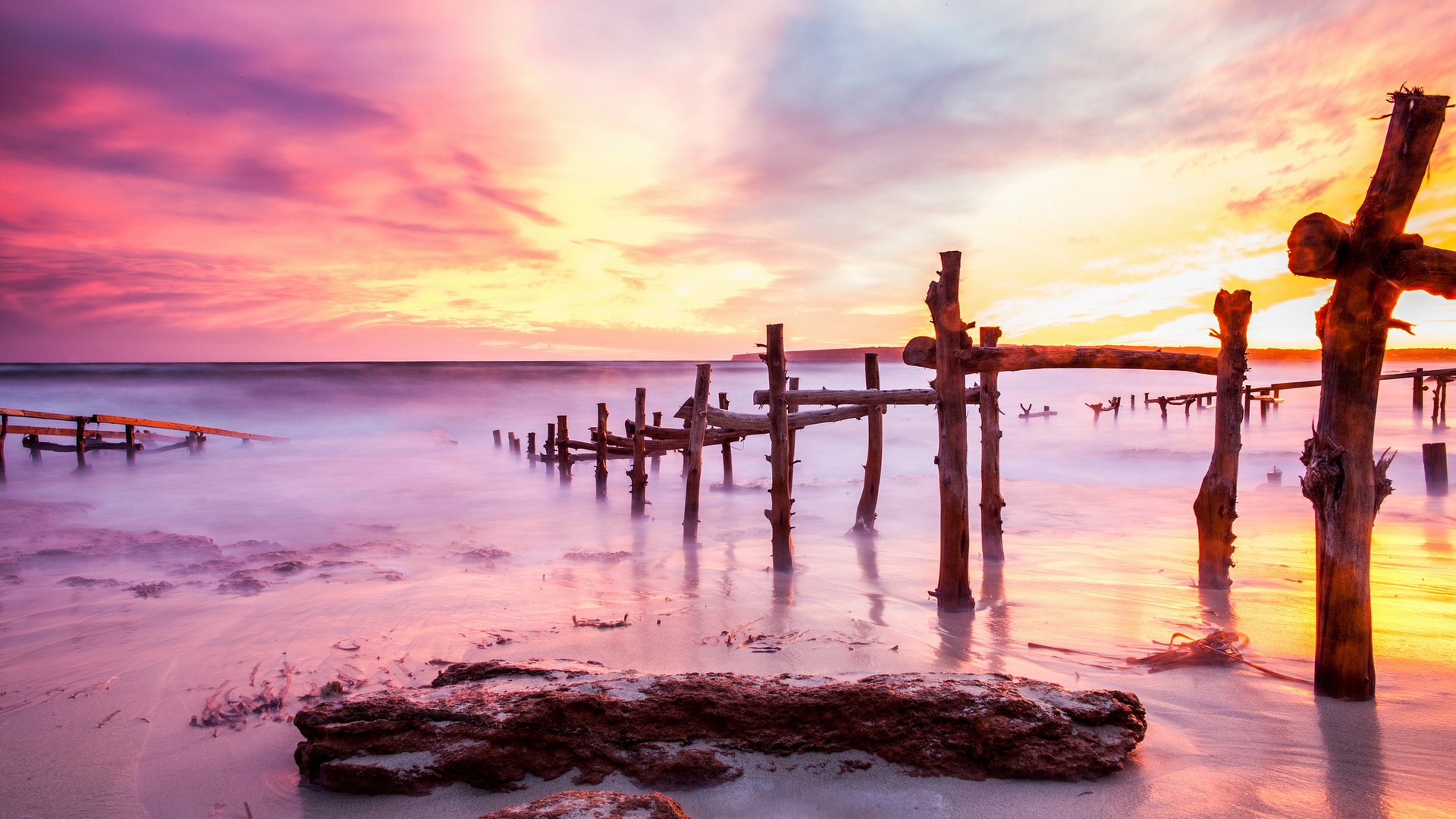 Wooden pier ruins at sunset beach HD Wallpaper