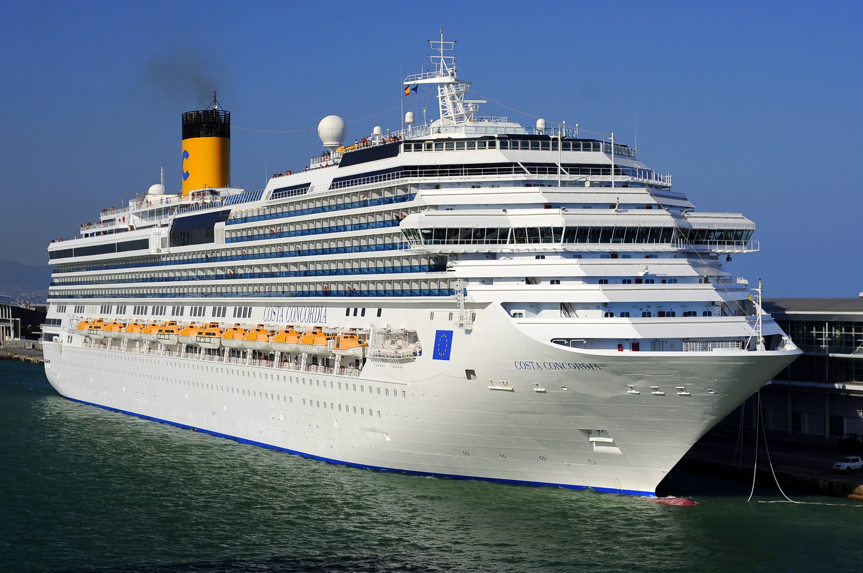 Costa Concordia cruise ship docked at a pier HD Wallpaper