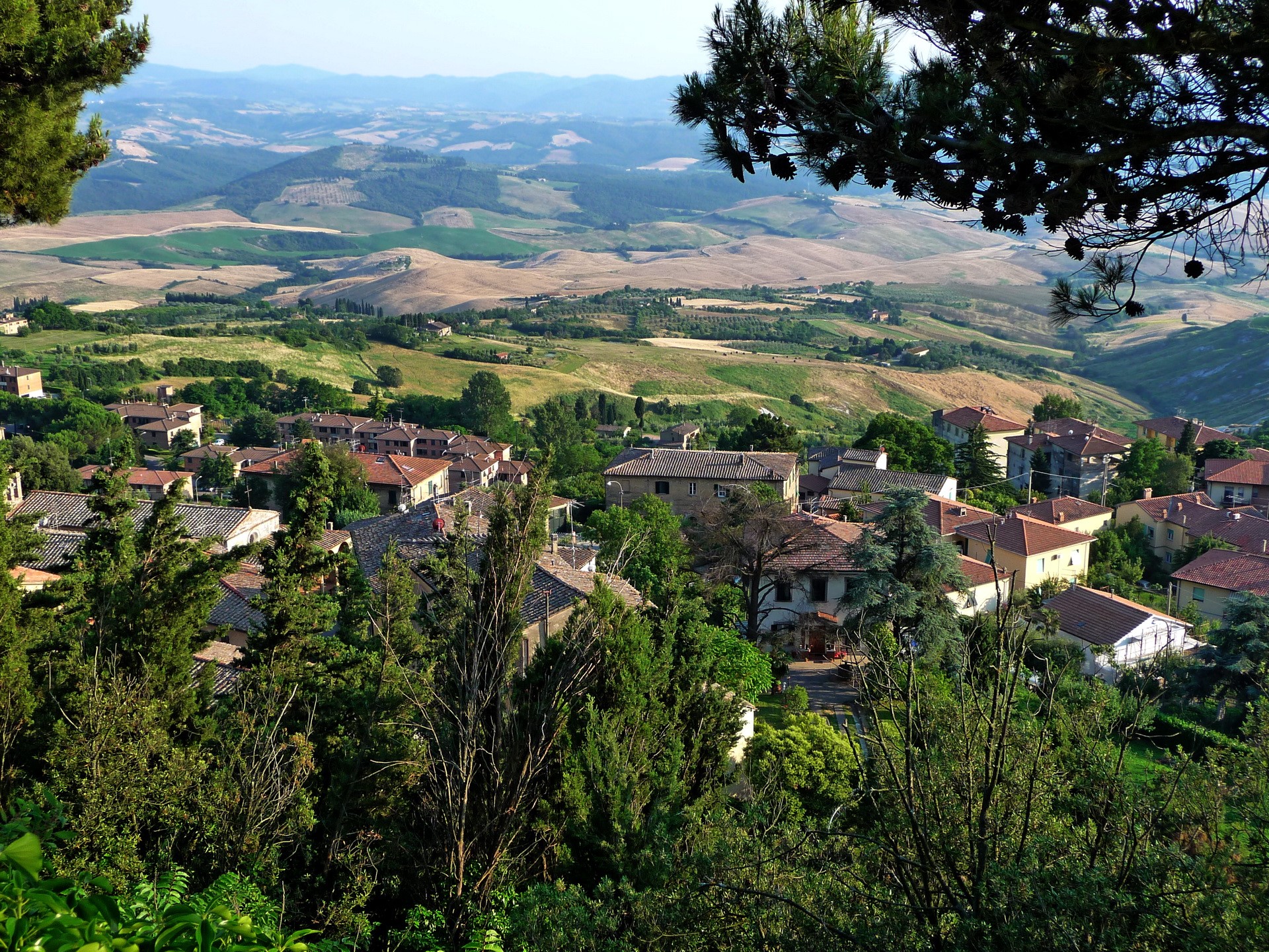 Tuscan village nestled in rolling hills, Italy HD Wallpaper