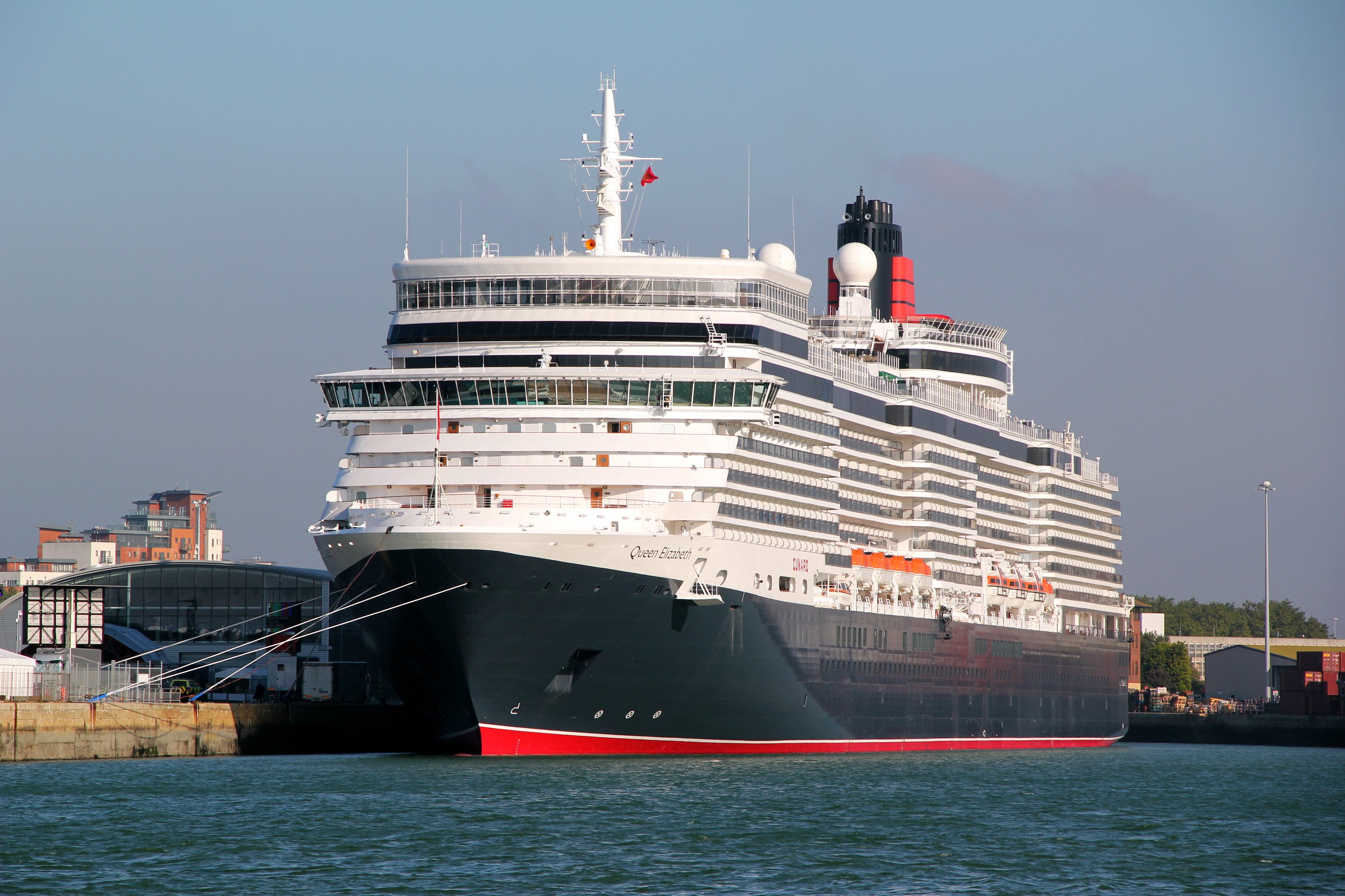 Queen Elizabeth cruise ship docked at a harbor HD Wallpaper