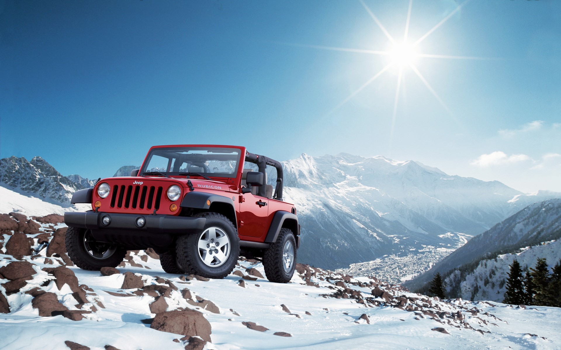 Red Jeep Wrangler Rubicon in snowy mountains HD Wallpaper