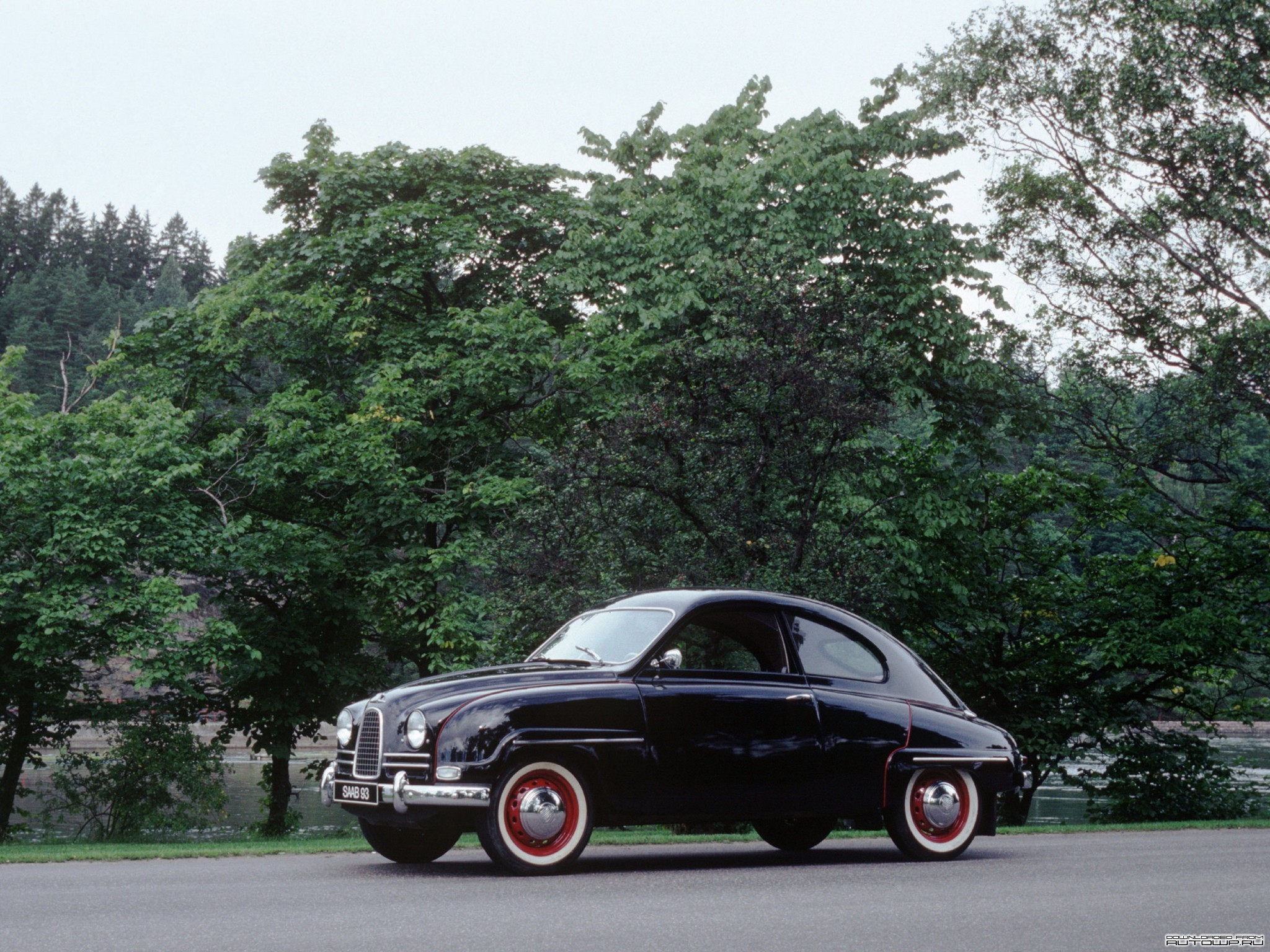 Black Saab 93 parked on a road with trees HD Wallpaper