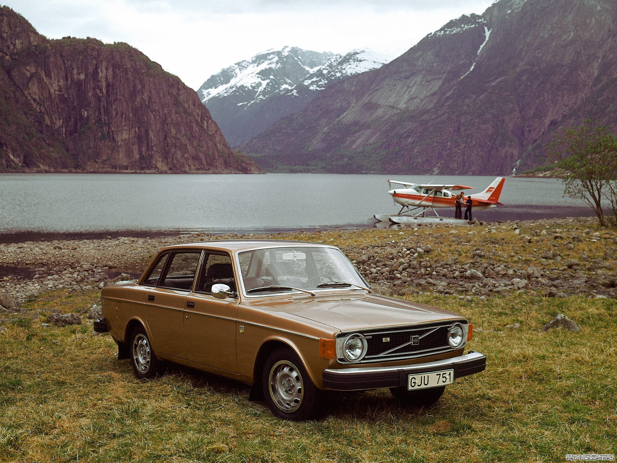 Volvo car parked by a lake with a seaplane HD Wallpaper