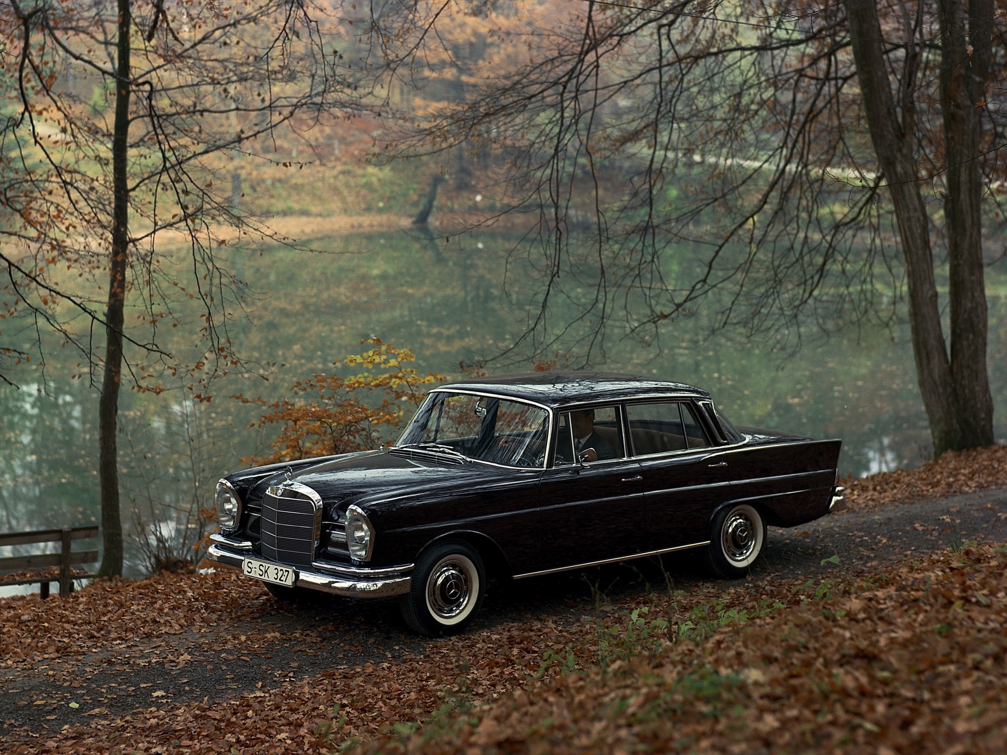 Black Mercedes-Benz W111 parked by a lake in autumn HD Wallpaper