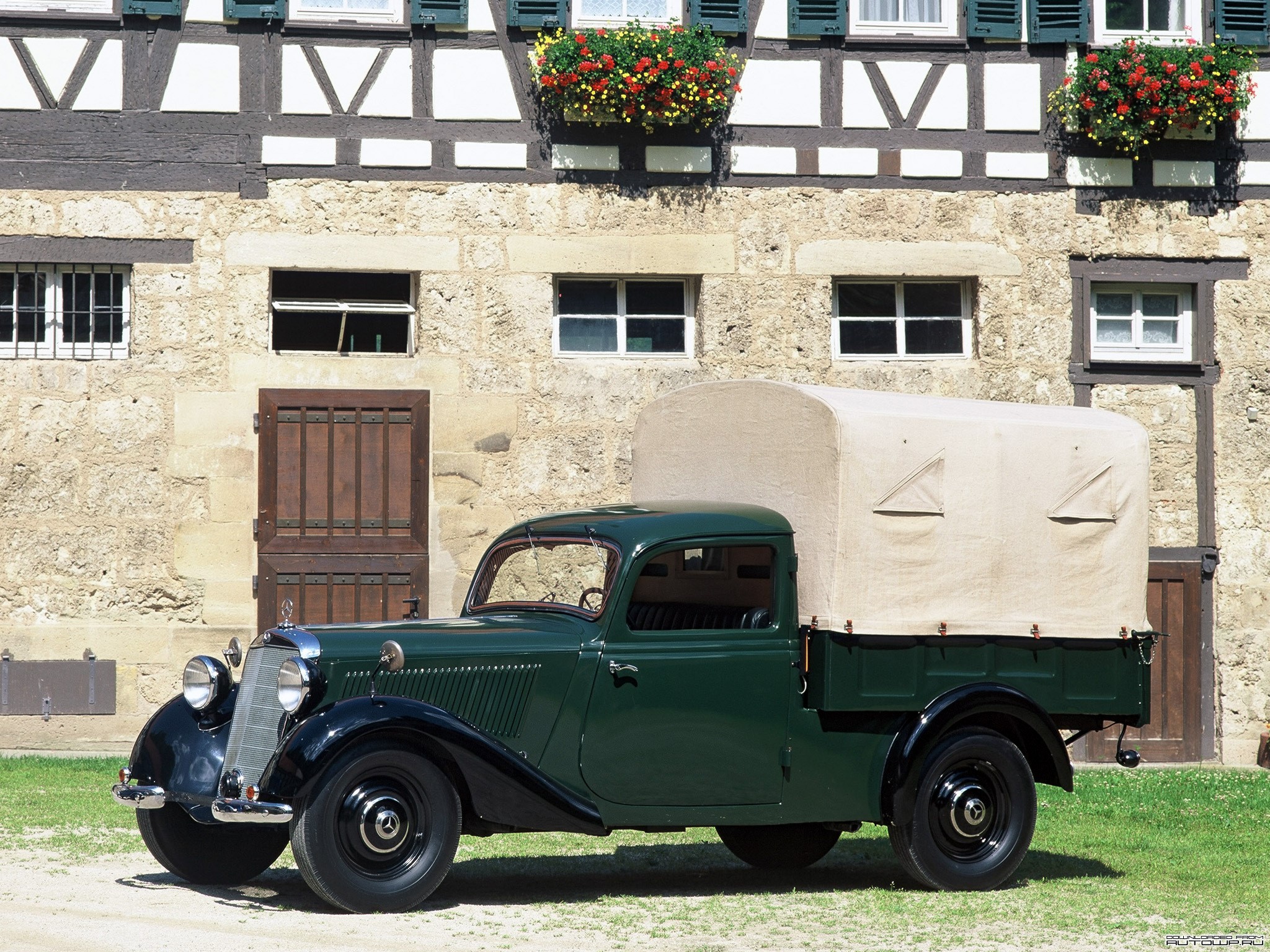 Green Mercedes-Benz Pickup Truck in front of a historic building HD Wallpaper