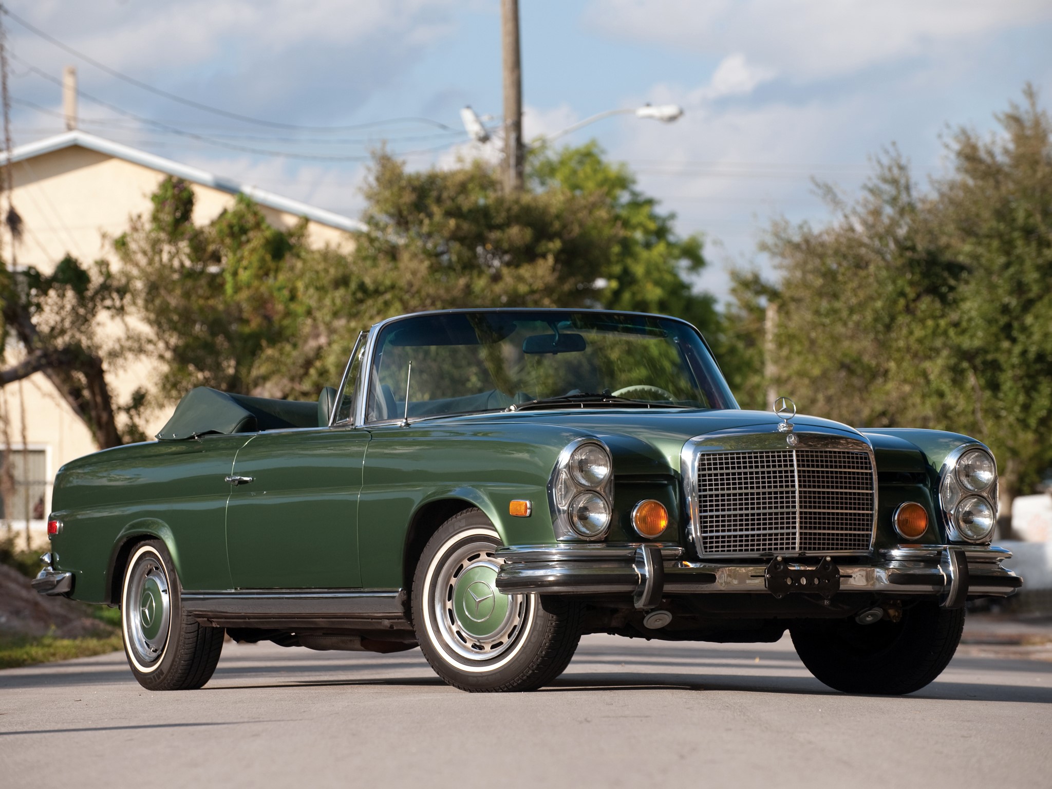 Green Mercedes-Benz convertible parked on a street HD Wallpaper