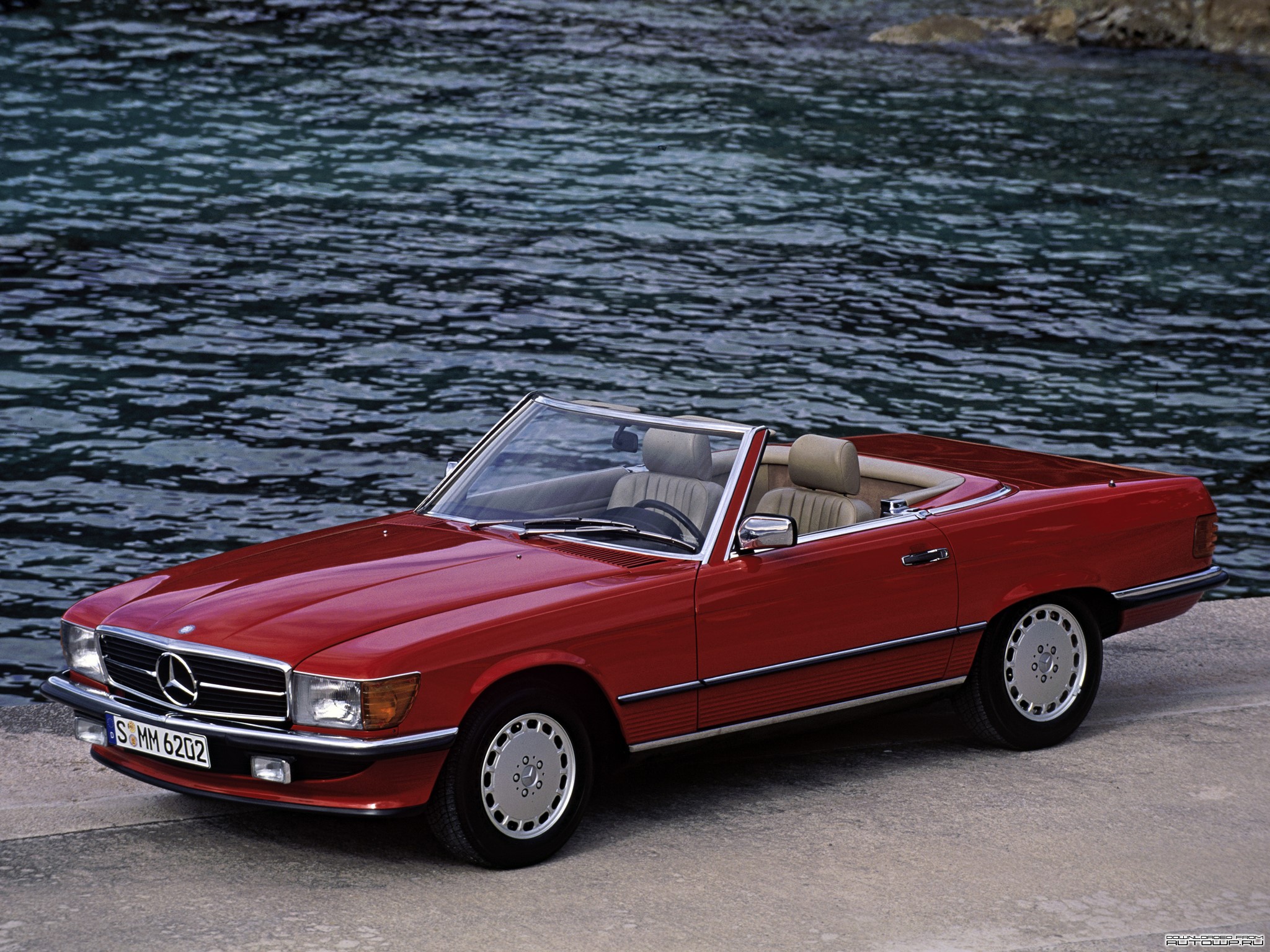 Red Mercedes-Benz SL convertible parked by the water HD Wallpaper