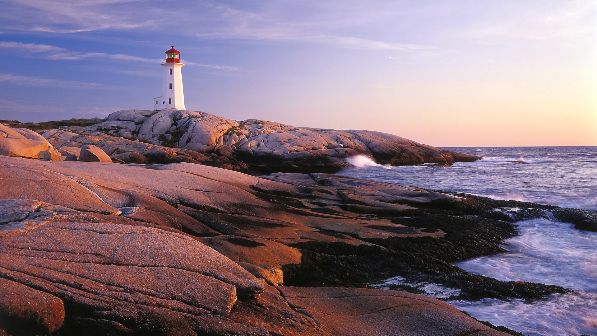 Peggy's Cove Lighthouse on rocky coast at sunset HD Wallpaper