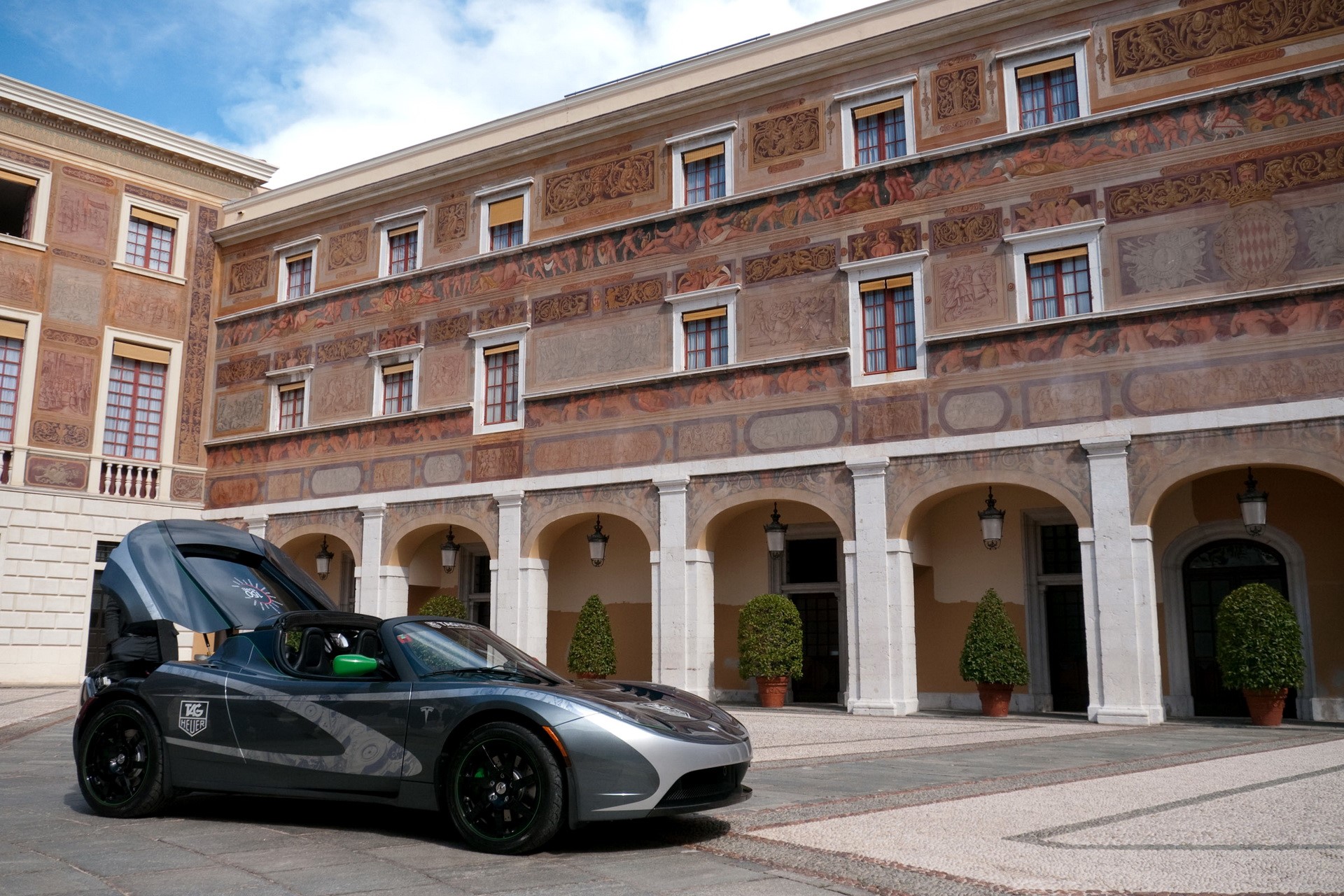Tesla Roadster in front of a historic building HD Wallpaper