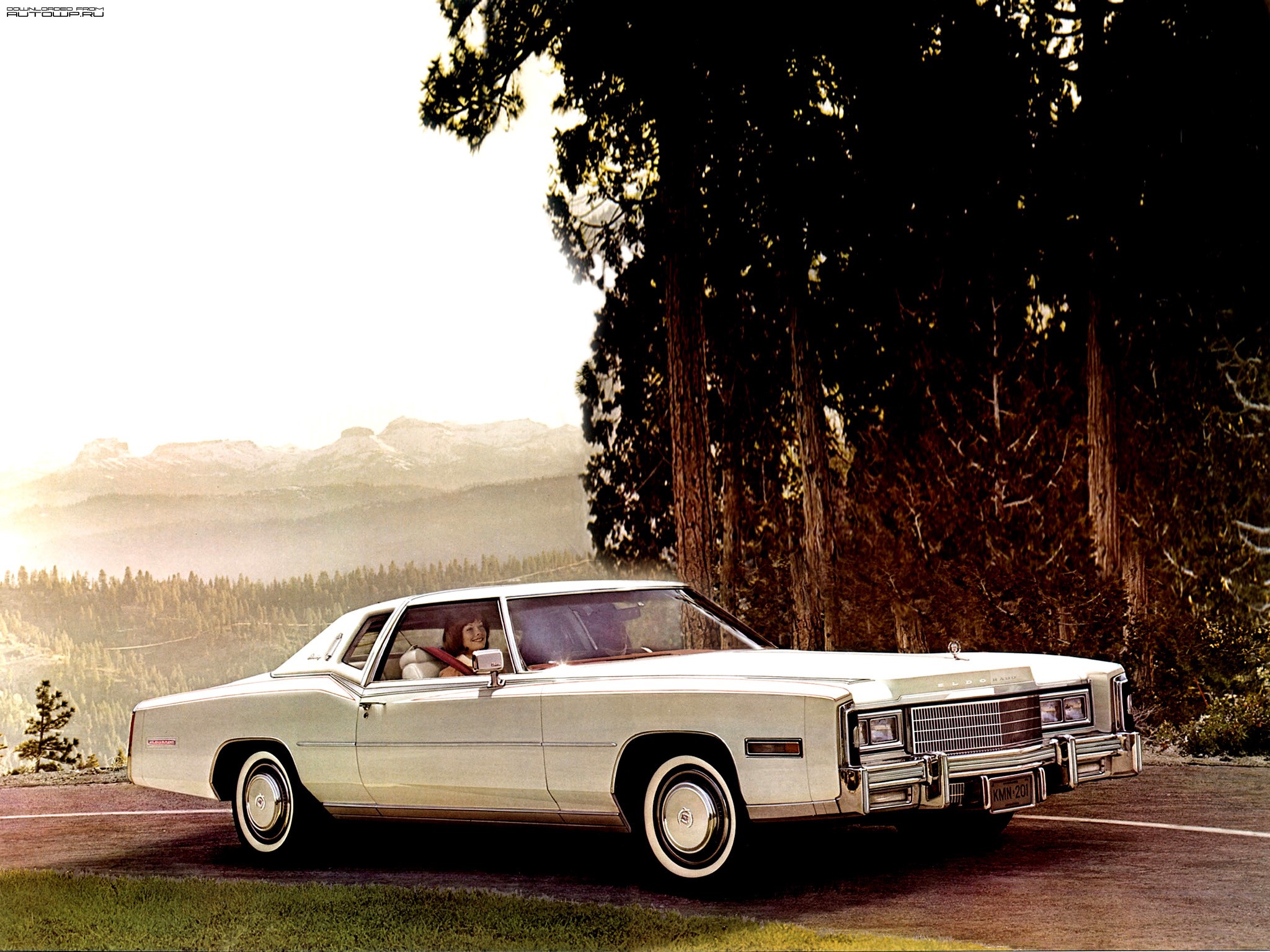 1977 Cadillac Eldorado Coupe driving on a mountain road HD Wallpaper