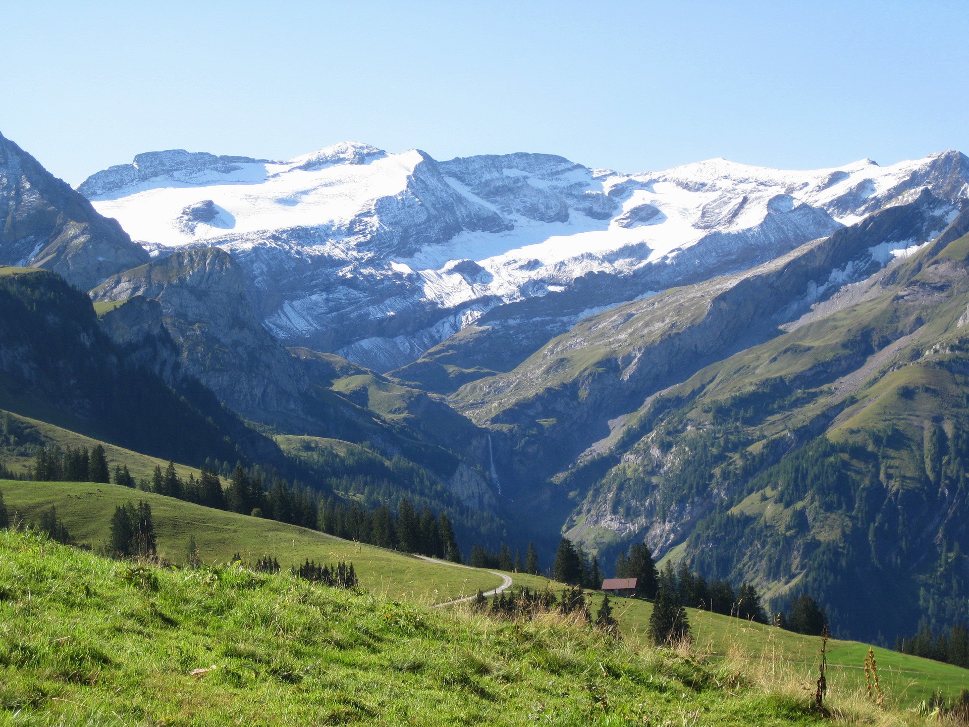 Snow-capped mountains in Switzerland with green valleys HD Wallpaper