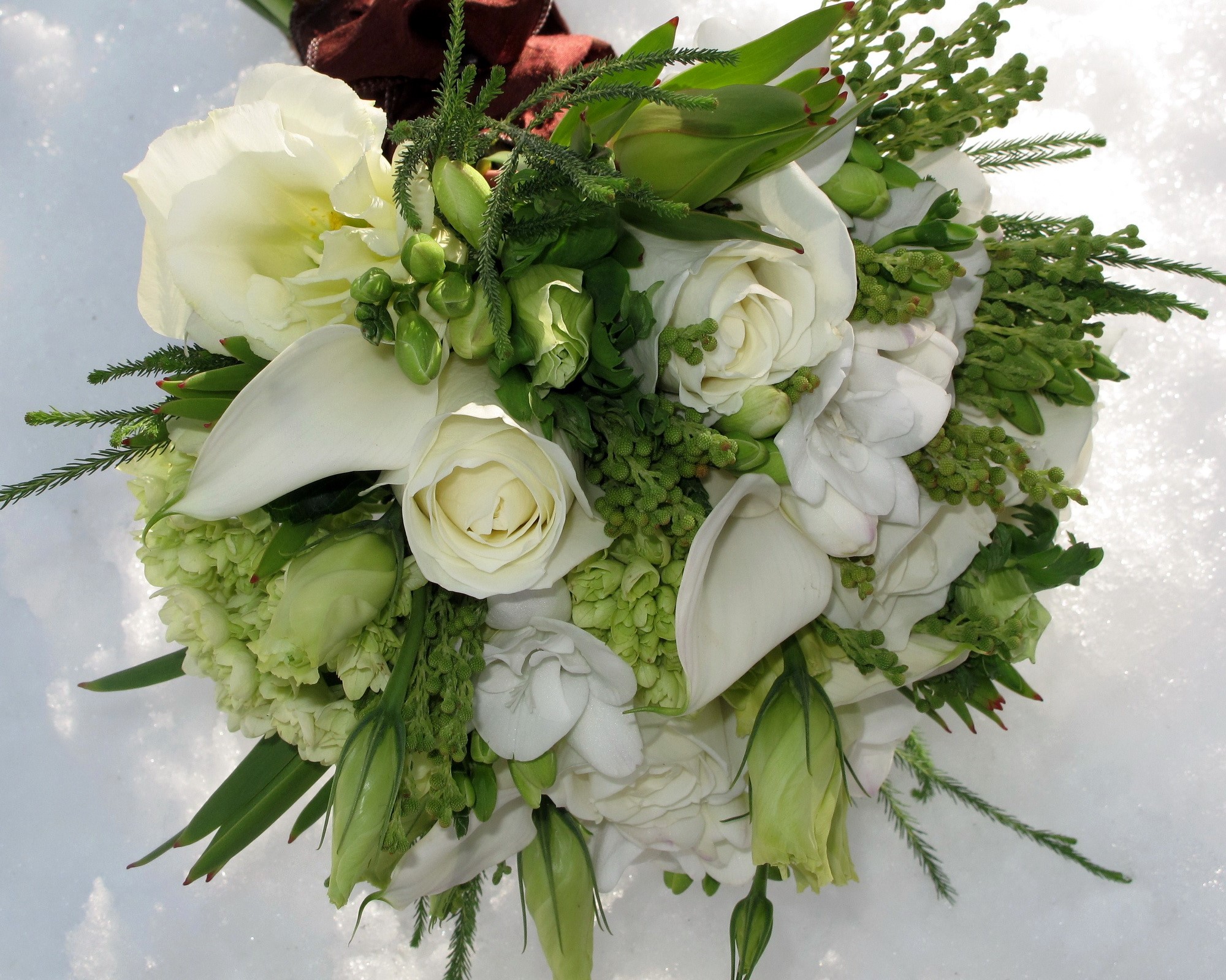 White and green floral bouquet on snow HD Wallpaper